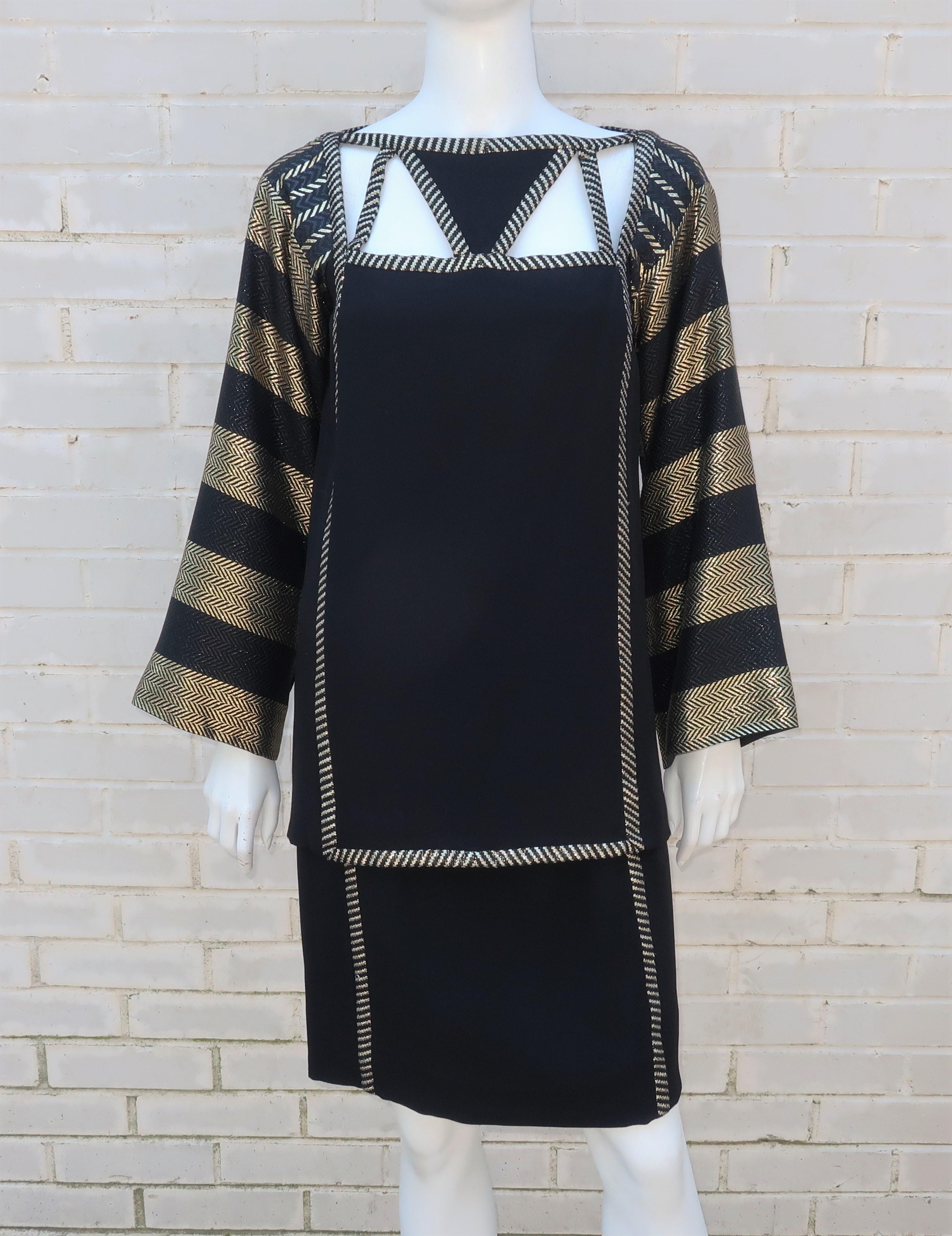 Famous for dressing fabulous divas in sequins, Bob Mackie proves with this 1970's Art Deco revival ensemble that he can dazzle without spangles and feathers.  The two piece black crepe dress consists of a tunic and skirt decorated with gold lamé