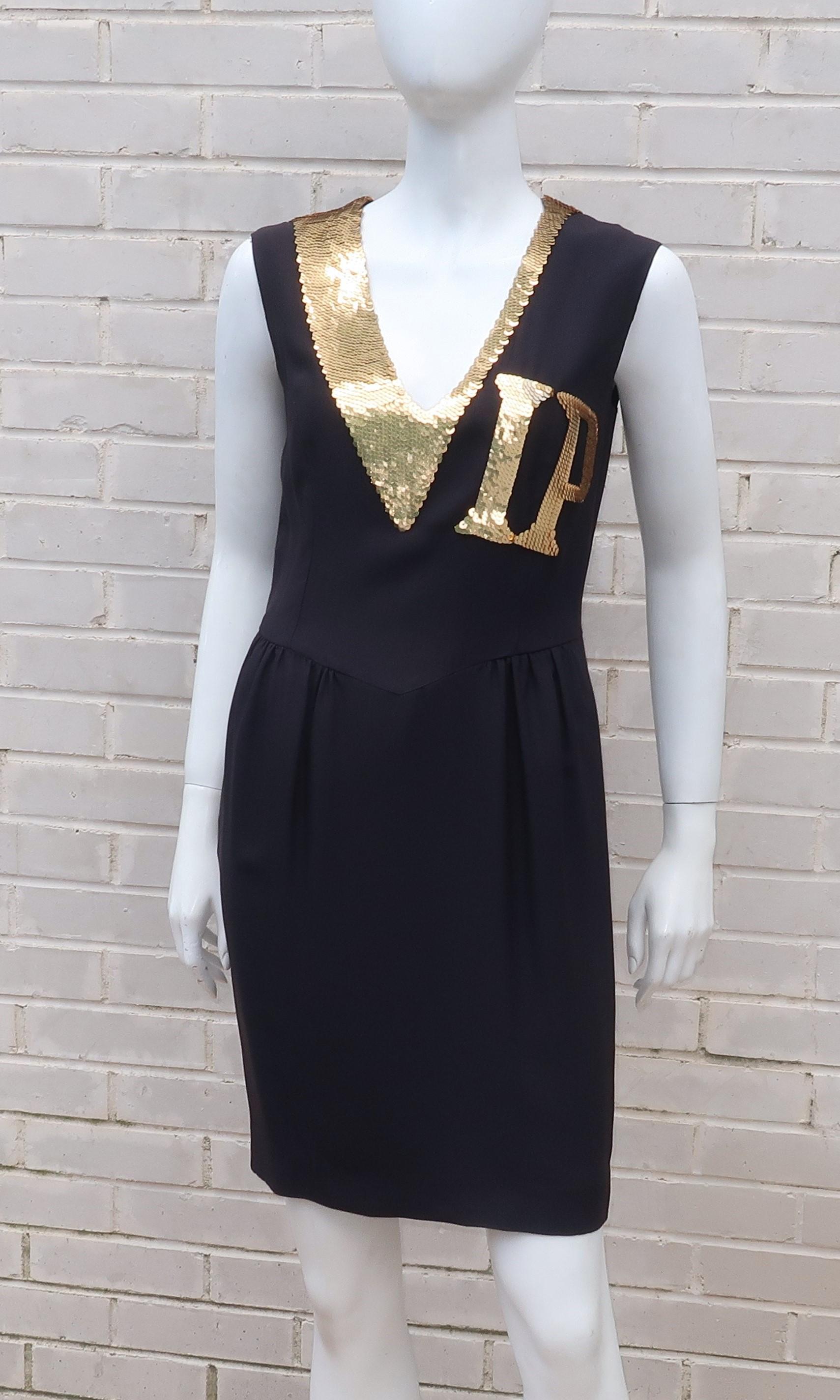 Moschino has got your pass!  In keeping with his irreverent style, Franco Moschino’s black rayon cocktail dress announces VIP status in gold sequins with the intent of framing the wearer’s face in style.  The sleeveless silhouette zips and hooks at