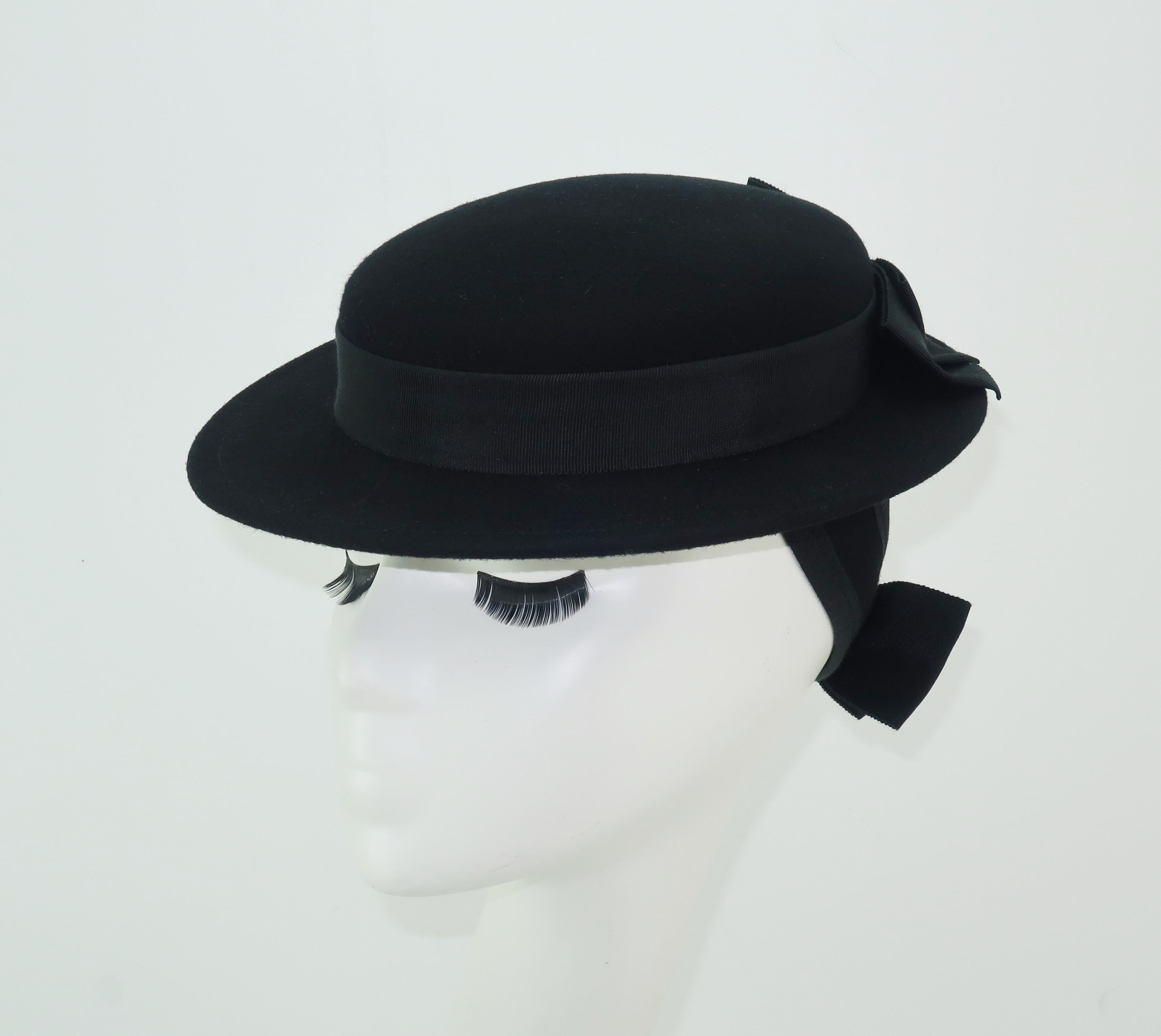This Sonni hat is cute and clever!  A perfect combination for a 1950's revival of a classic 1940's 'tilt' hat silhouette in a versatile black wool felt edged in grosgrain ribbon and accented with bows at the back.  Tilt hats often provide back
