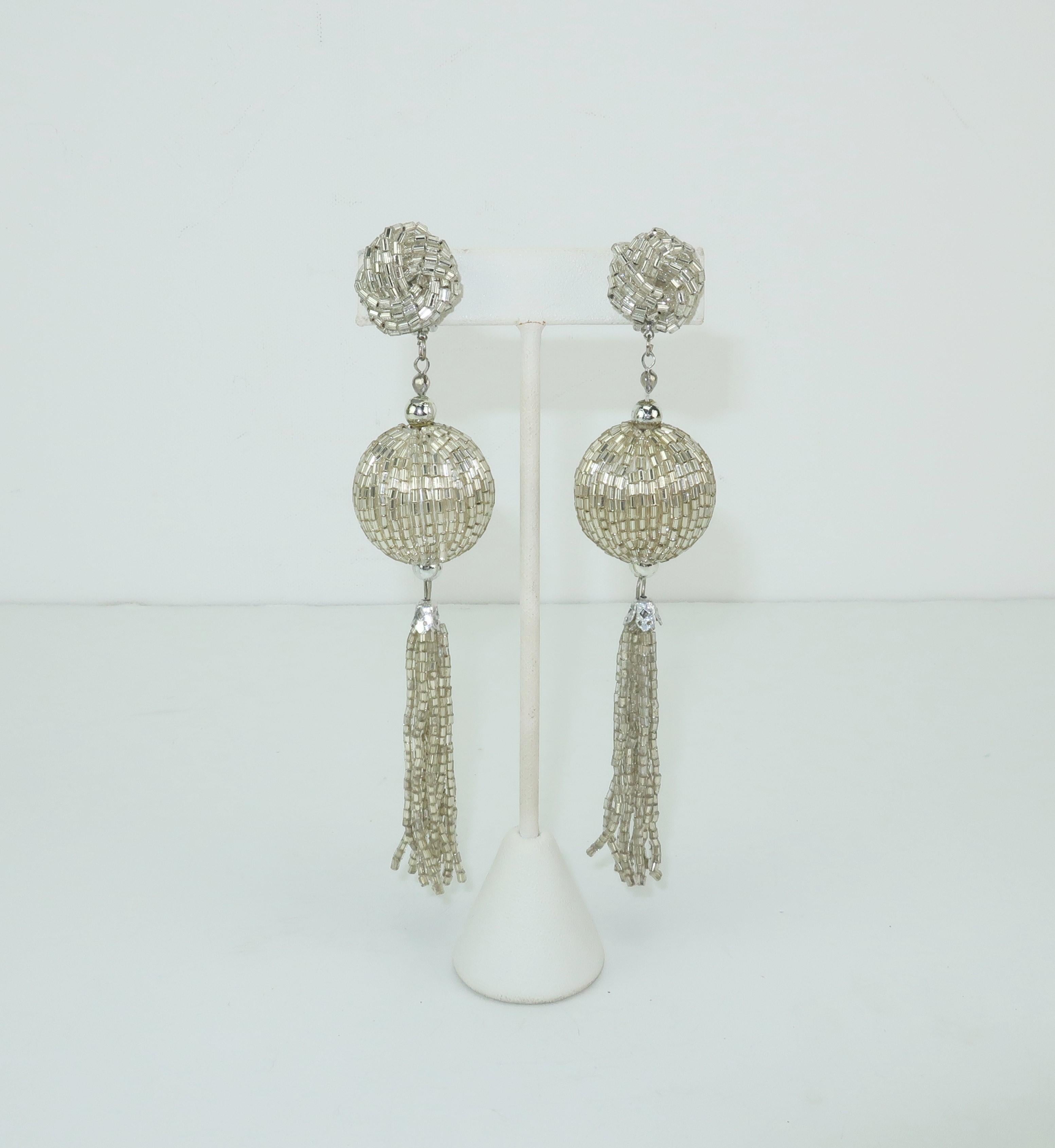 A disco diva's delight!  These 1970's clip on earrings are fully covered in silver beads and feature an articulated dangle in a tassel style silhouette.  Lightweight enough for all evening wear and big enough to make a statement.  Unsigned and in