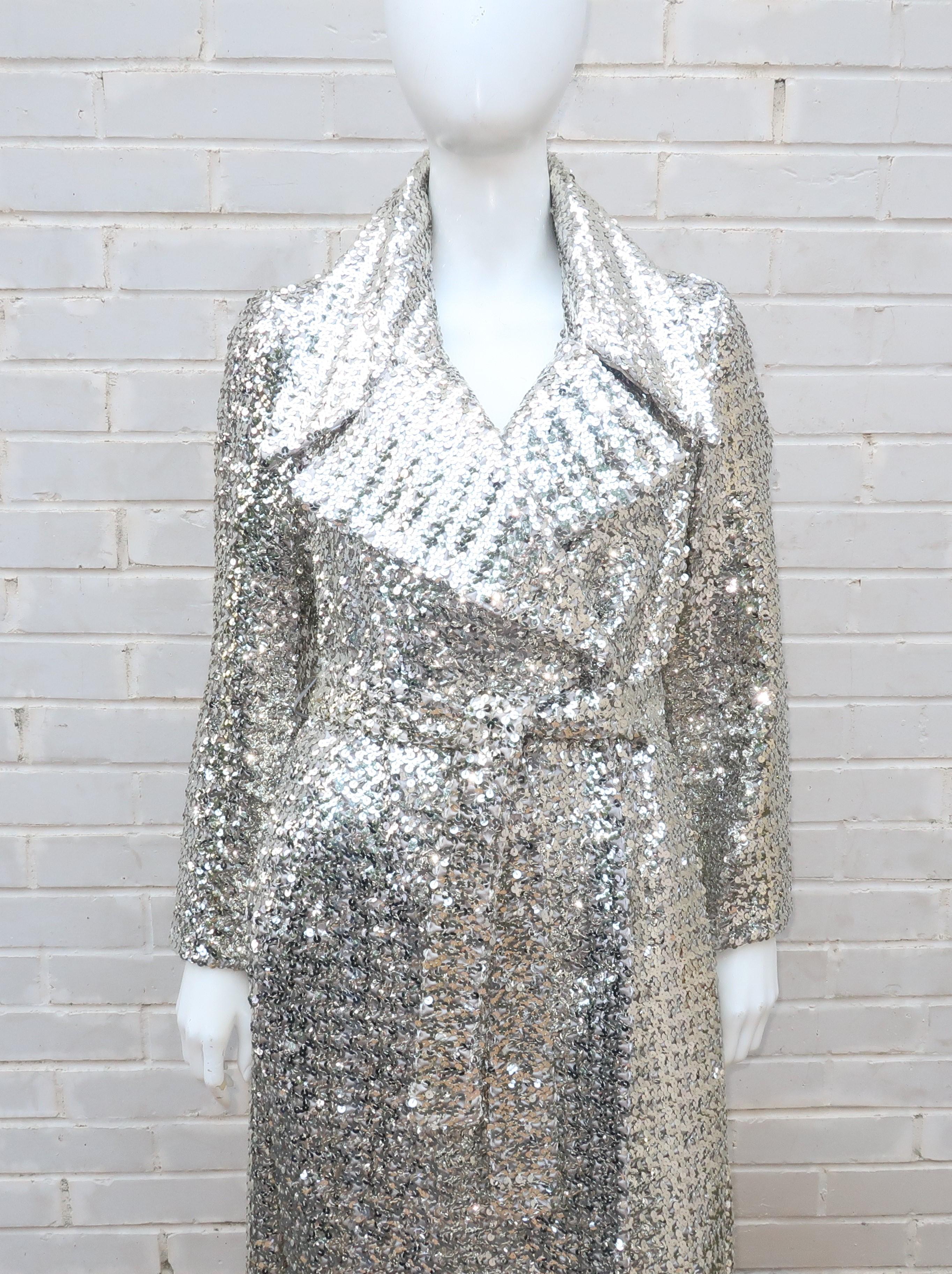 Don't save this one for a special occasion!  Wear it anytime and every time you want to make a splash.  This trench style coat is fully embellished with mirrored silver sequins and provides a 1970's period perfect look with an exaggerated collar and