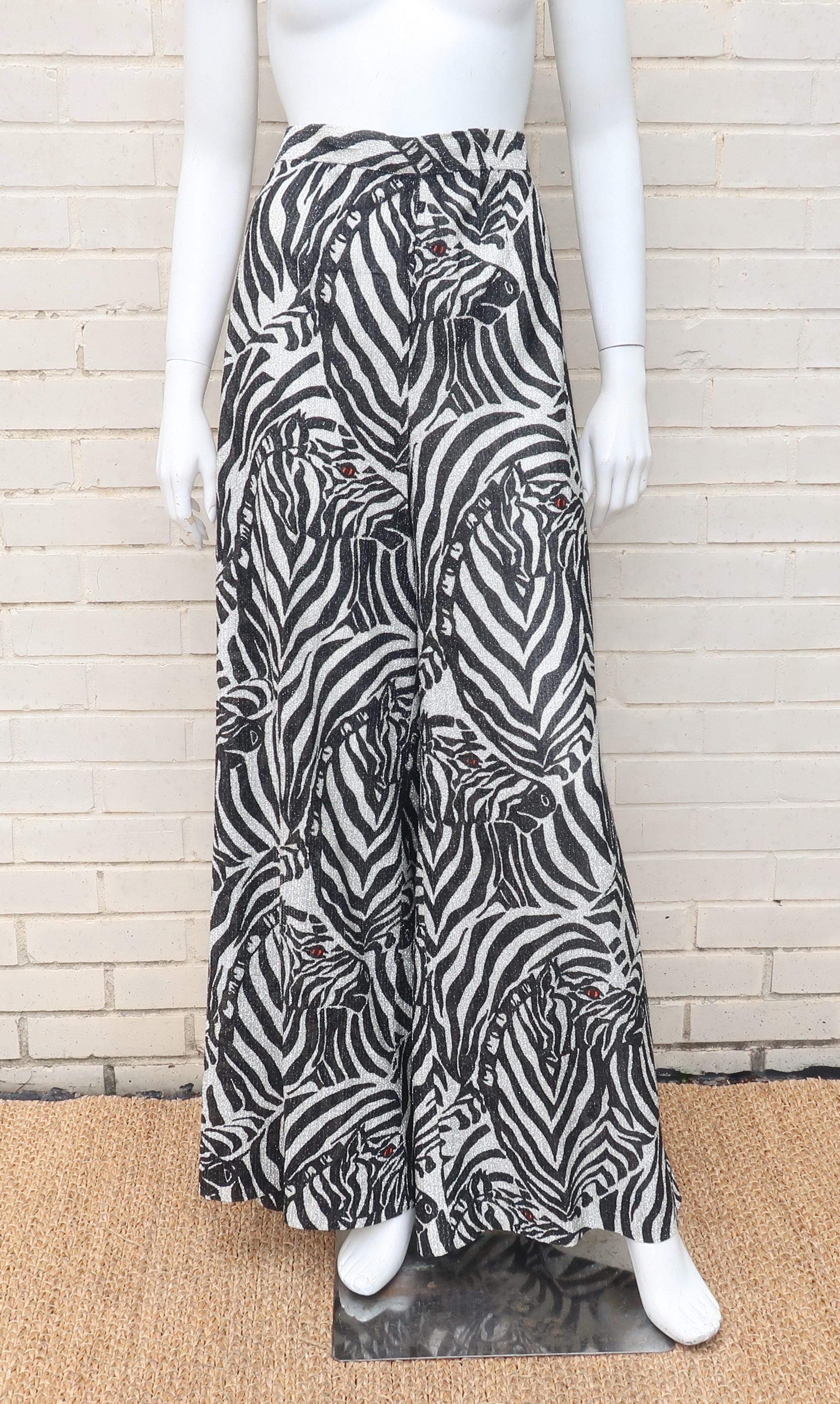 Channel your inner wild child with this fabulously fun pair of 1970's zebra print silver lamé palazzo pants.  The high waist pants zip and hook at the back with a smooth fit at the hips flaring to wide legs full enough to create the appearance of a