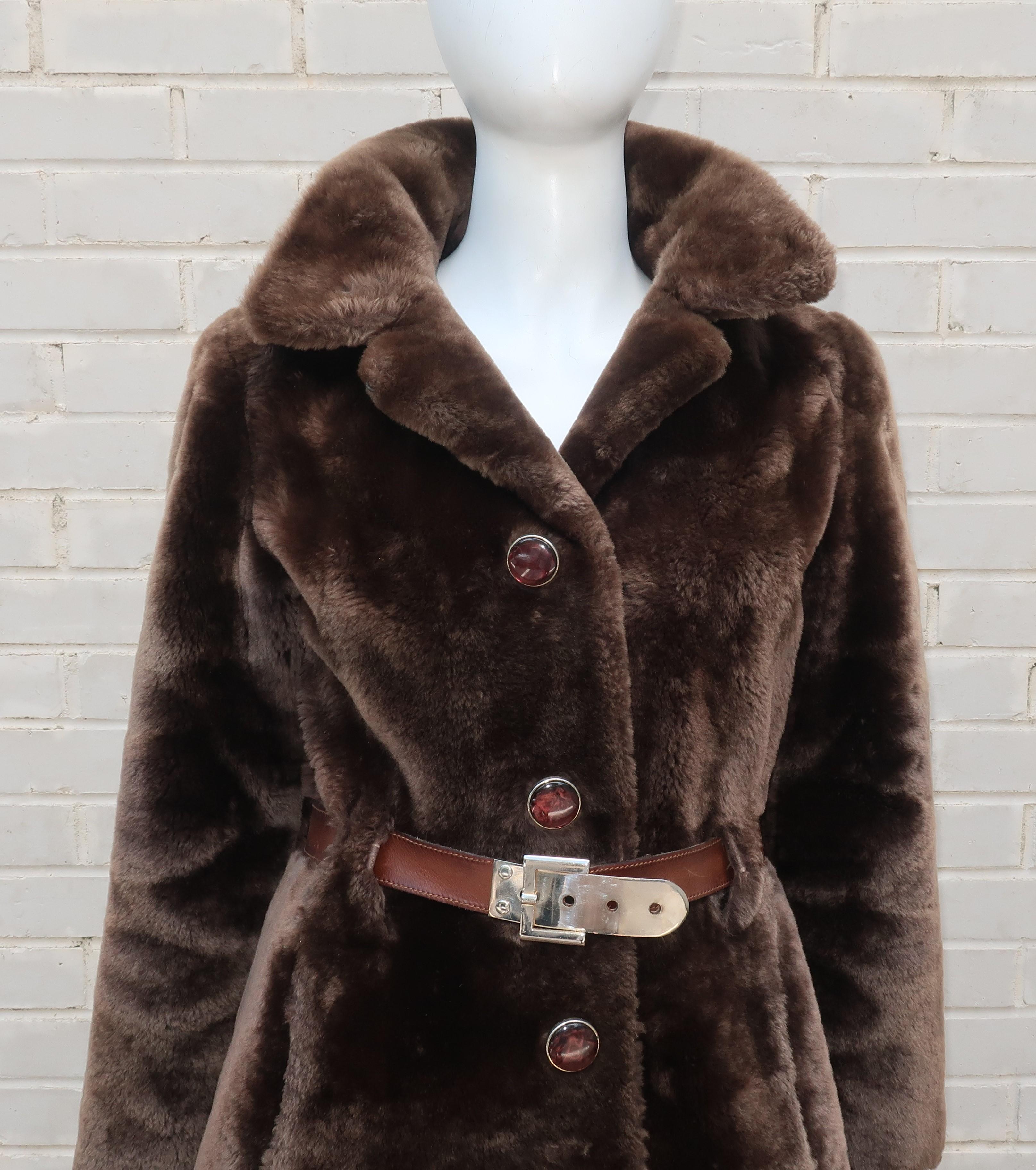 Revillon furriers has been providing luxury goods from Paris since the 1700's.  This brown mouton coat not only offers a practical topper for cold winters but also the stylish mod aesthetic of the 1960's.  The coat features decorative marbleized