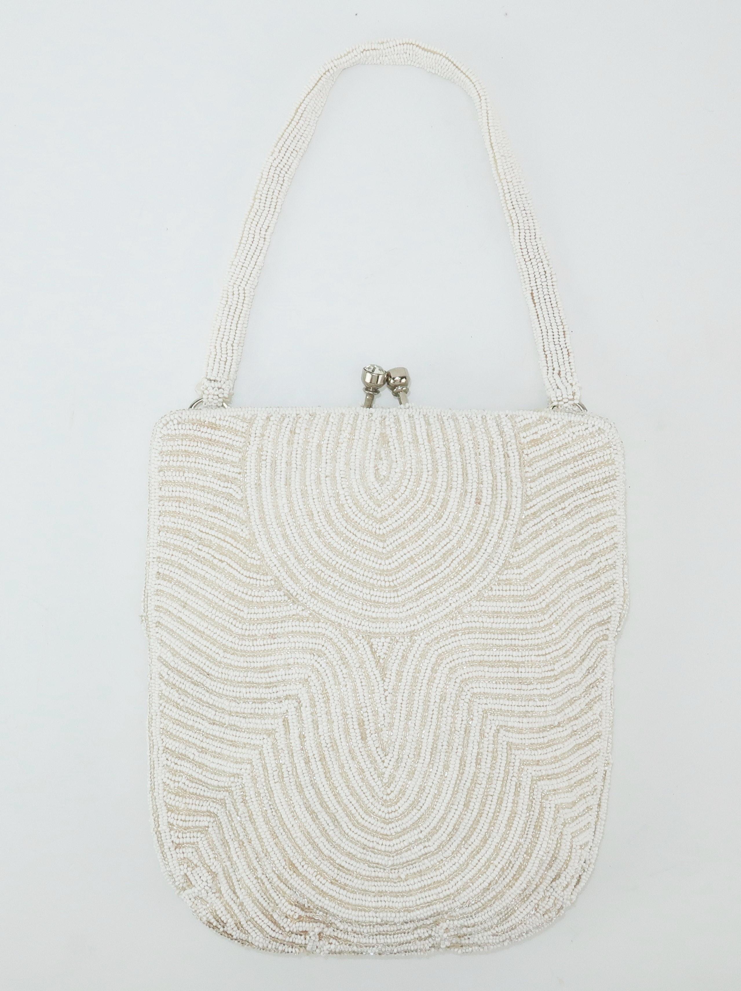 Hilde Walborg founded her company in the 1940's and was always in search of the best handmade beading for her designs.  This 1950's evening handbag was hand beaded in Belgium incorporating an Art Deco style design in white and silvery clear seed