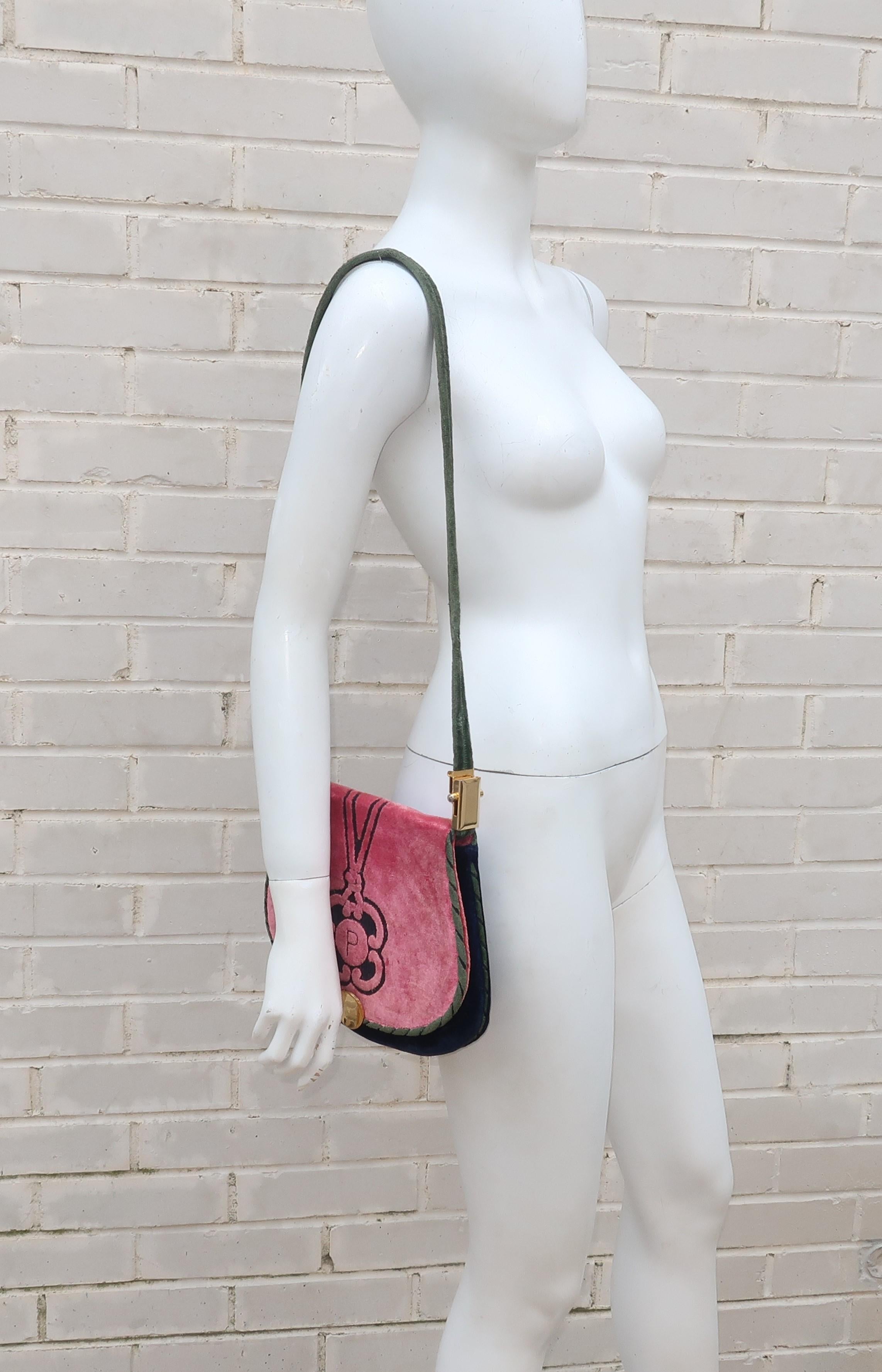 This C.1970 Cesare Piccini handbag is fabricated from a combination of blue, green and an eye catching watermelon pink velvet.  It features an adjustable shoulder strap which converts from long to short with a simple slide of a gold tone buckle. 