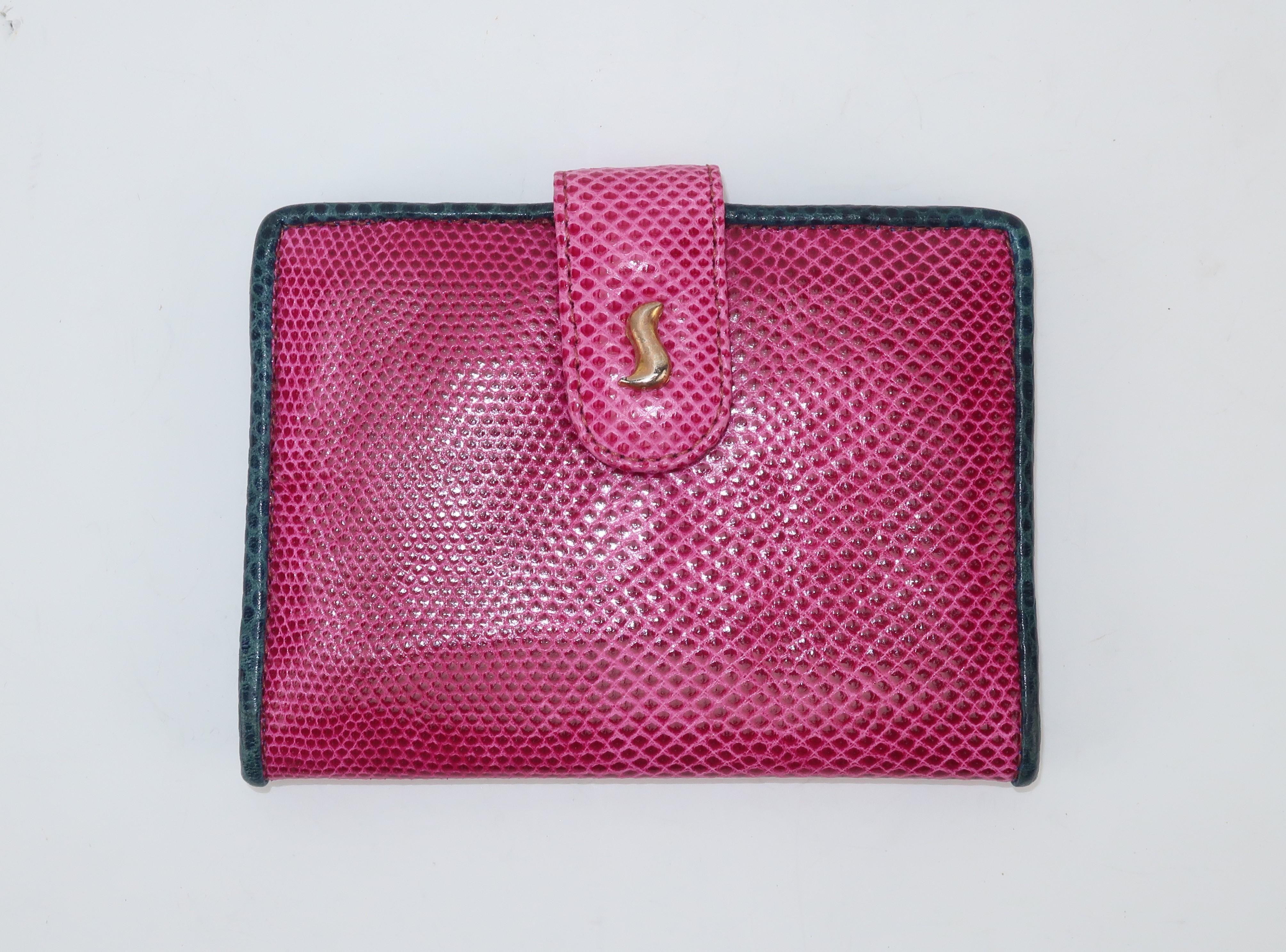 This vintage card case is as unique in style as the handbags made by Sharif, a leather goods company specializing in exotic materials.  The practical case also serves a colorful purpose with a contrasting hot pink lizard skin trimmed in blue which