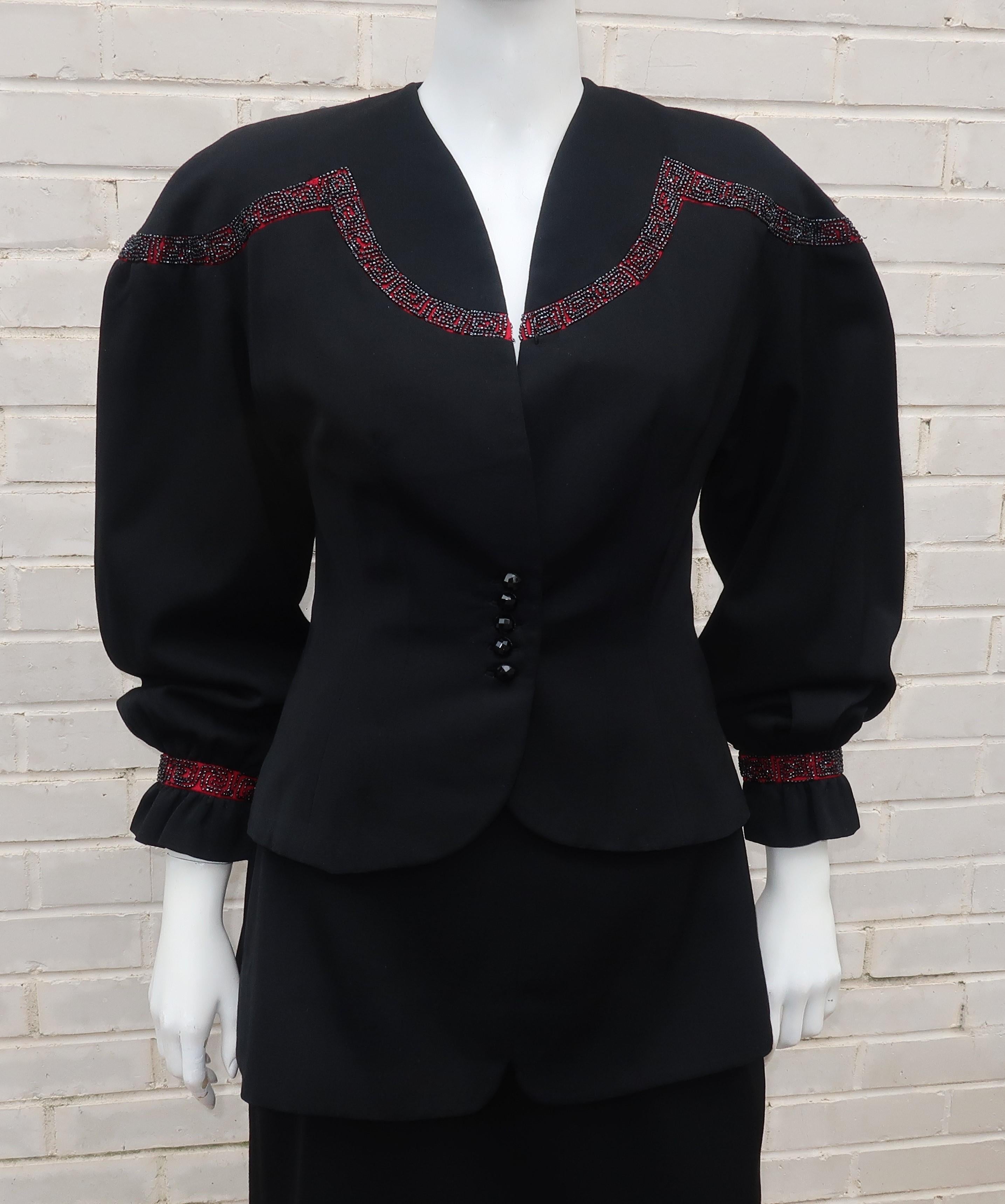 This 1940's black gabardine wool suit by Charles Kupersmith, a Chicago Illinois clothier, has drama one would expect from a Joan Crawford era look with a charming nod to Victorian design elements.  The jacket has beautiful balloon sleeves with snaps