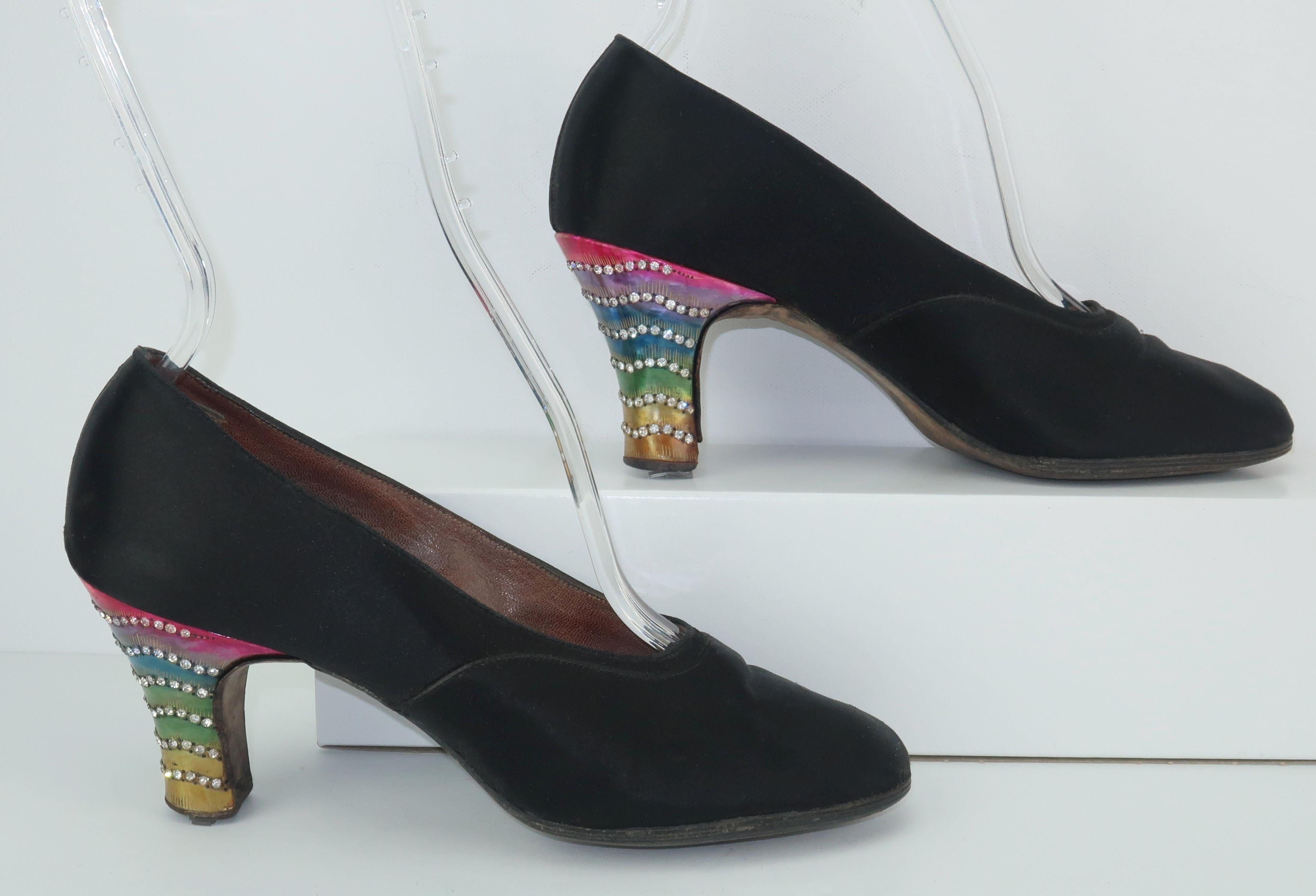 The celluloid heel is a remarkable piece of fashionable art from the past.  These 1920's black satin evening shoes are a flapper's delight with pearlized celluloid covered wooden heels in candy colors including fuchsia, lavender, peacock blue, green