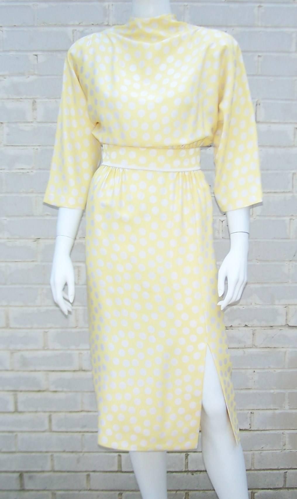 Everything is elegant about this Pauline Trigere dress.  Start with the buttery yellow lined silk fabric accented with silvery polka dots and move on to the cinch waist skirt topped with a blousoned dolman sleeve bodice...add a little shoulder pad