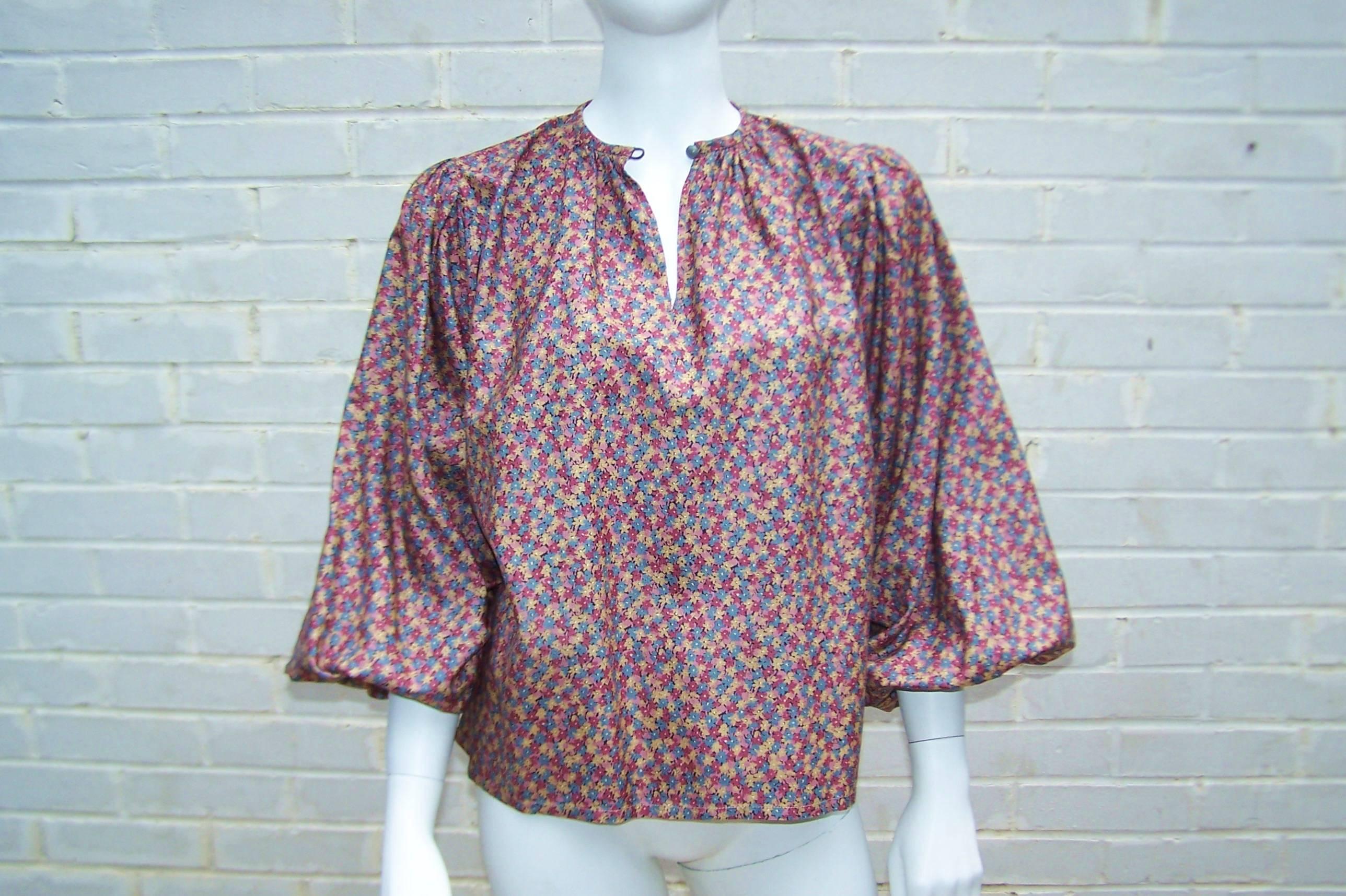 Perfect paired with jeans or high waist pants, this 1970s Yves Saint Laurent Rive Gauche peasant top is both beautiful and comfortable.  It buttons at the neck with elasticized cuffs and has the texture of silk taffeta.  Excellent vintage