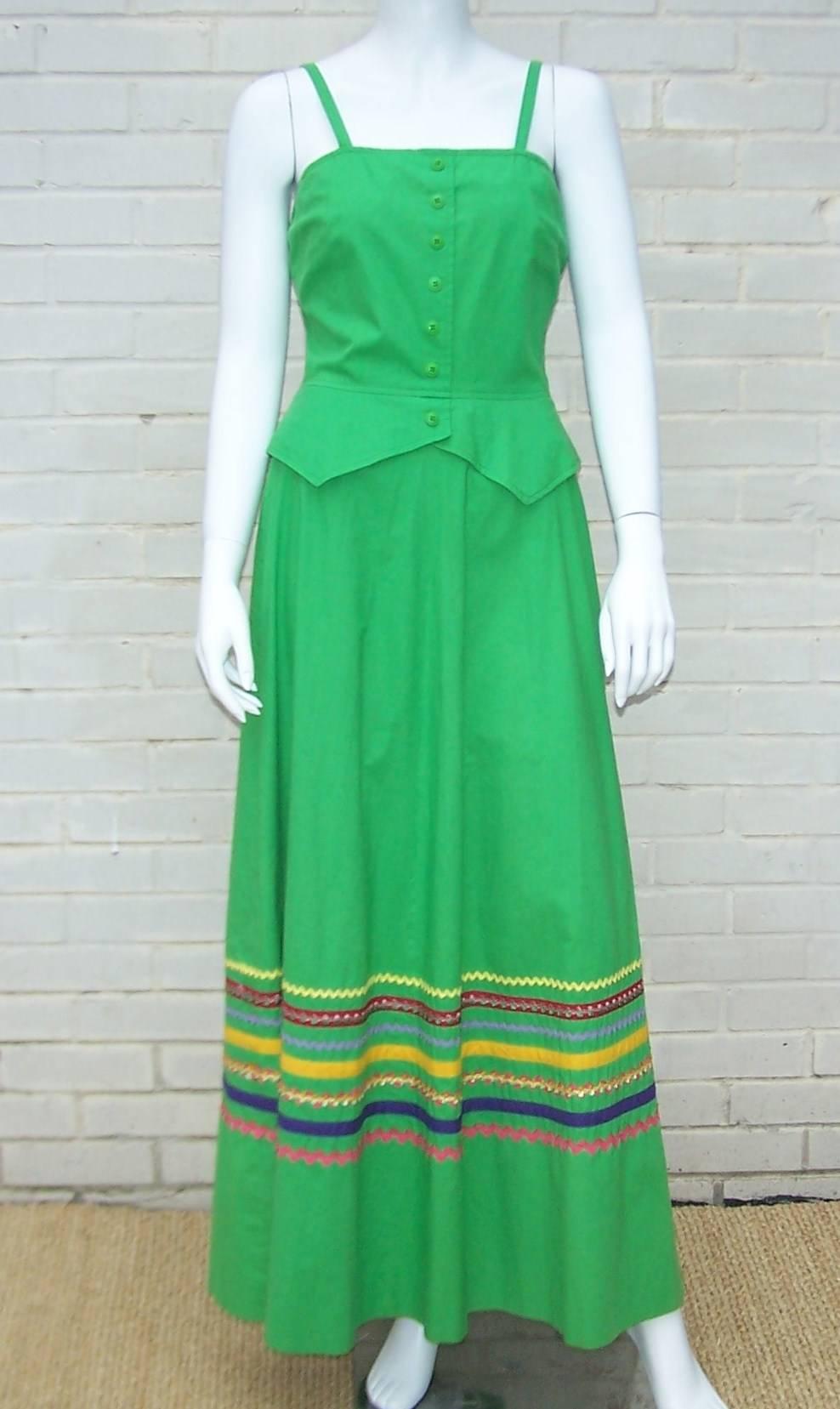 Add this 1970s cutie to your summer wardrobe for an easy sundress to wear for any occasion.  The vibrant green cotton is offset by colorful rick rack ribbon details and a faux peplum waistcoat style bodice.  The dress zips and hooks at the back and