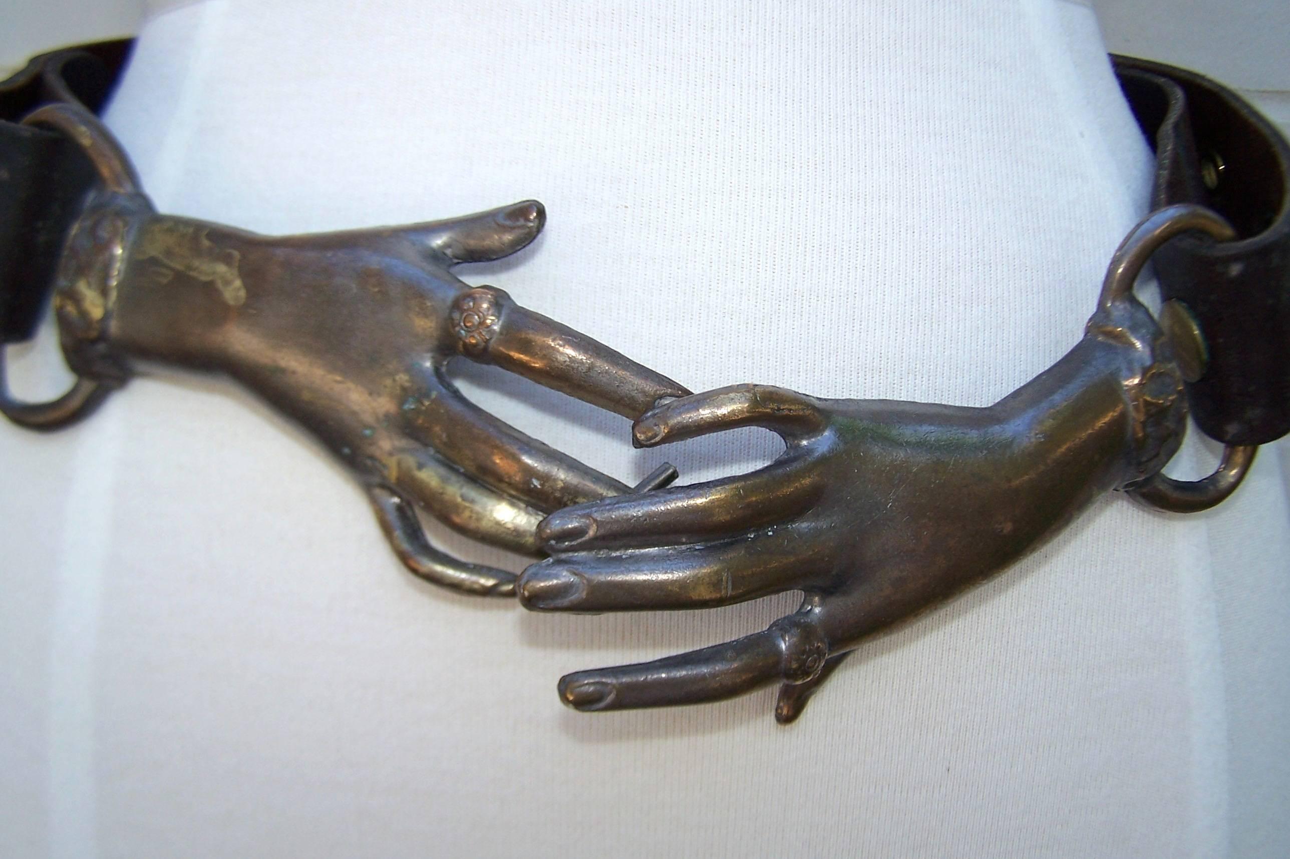 clasping hands belt buckle