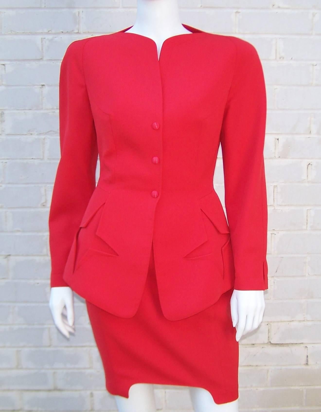 Stop traffic in this futuristic fiery red Thierry Mugler 2-piece suit.  As with all Mr. Mugler's designs, the details are endless and full of imagination.  The jacket fits snuggly in the torso and then flares out to reveal pockets shaped like