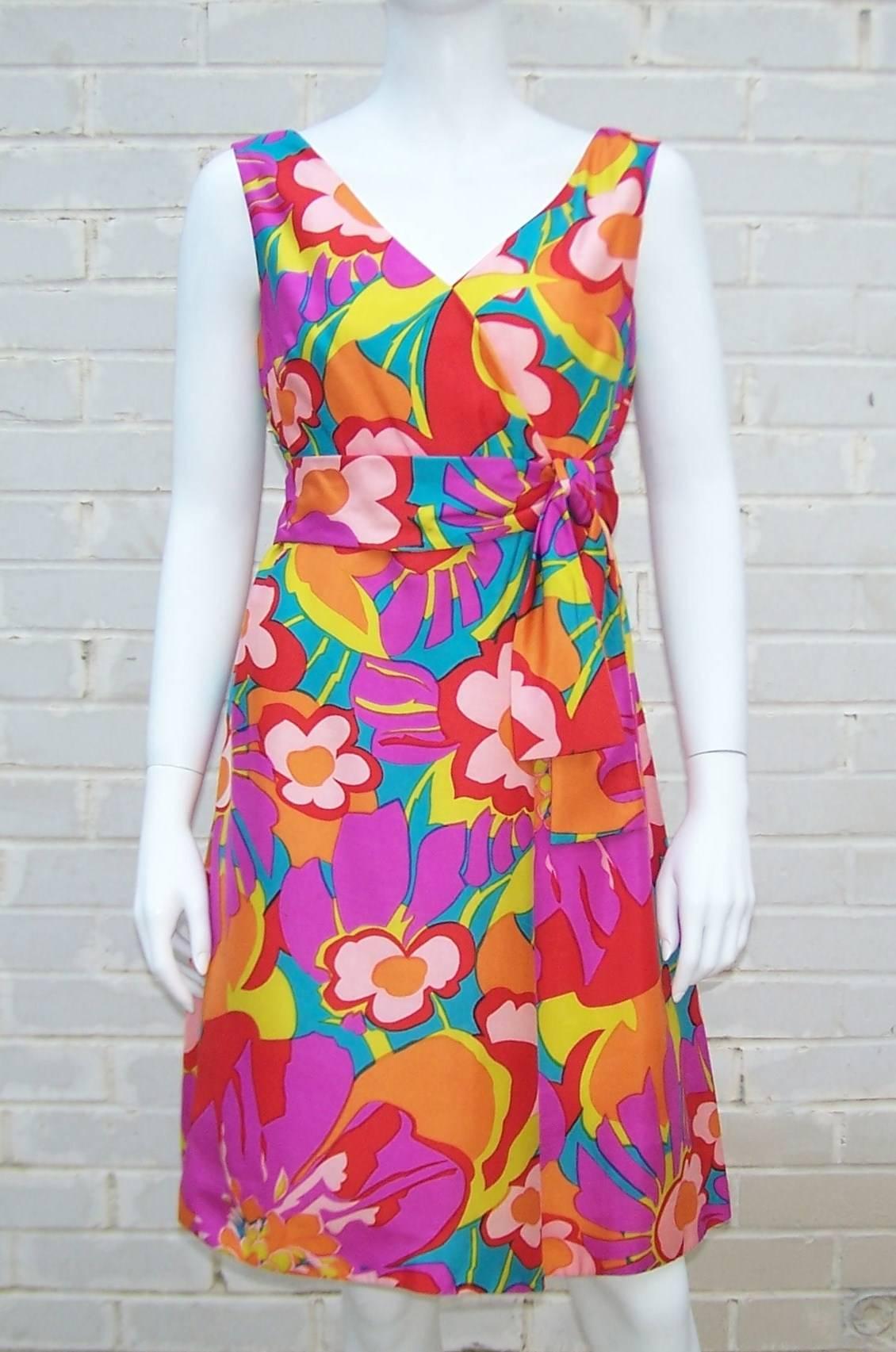 Bright and festive, this silk floral by Morton Myles for Jeunesse is a perfect dress for your summer arsenal.  Crisscross neckline, built-in modified empire sash and square back make for a flattering style.  The dress also features bright yellow