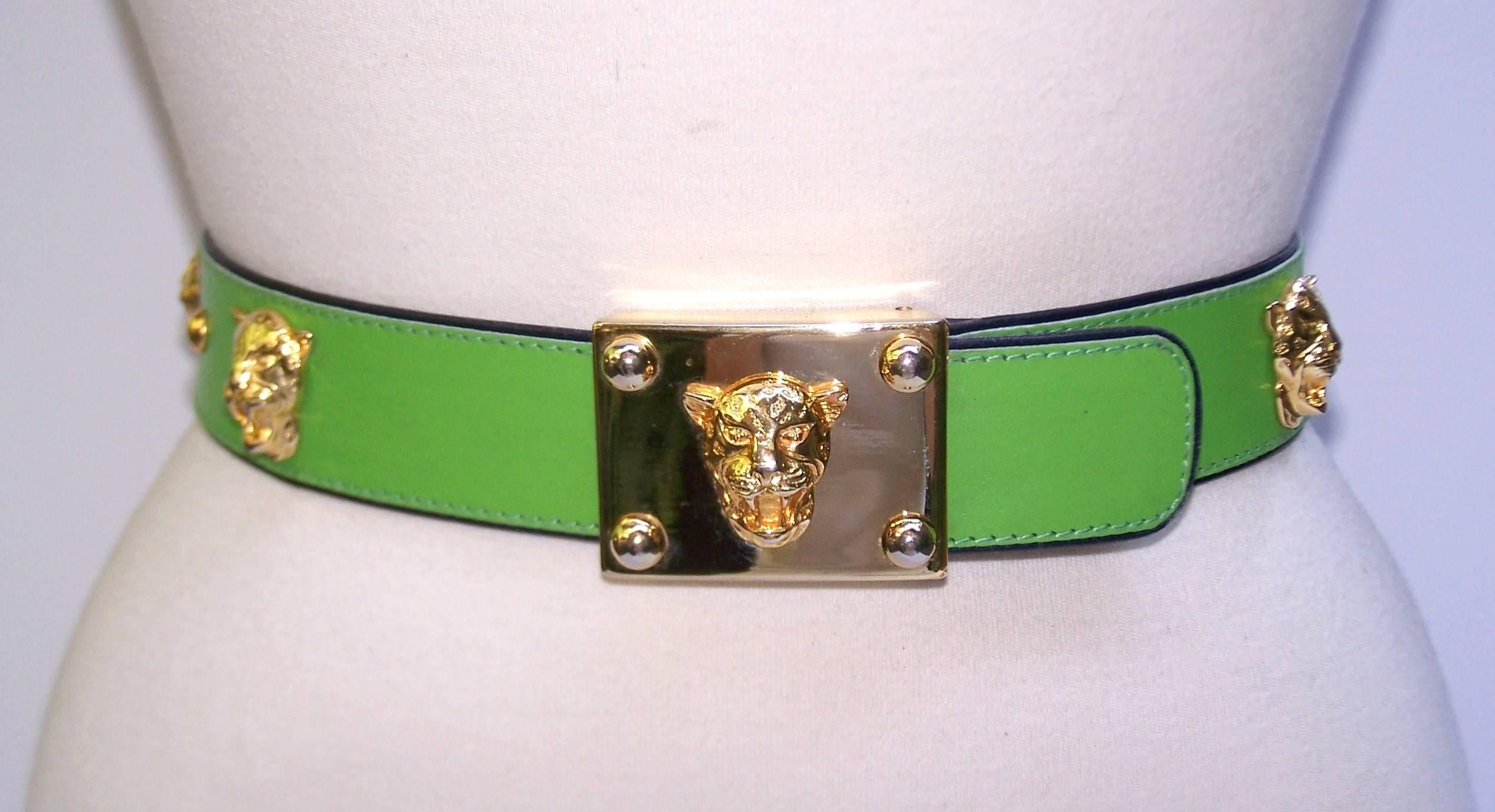 Preppie Chic!  This Escada bright green leather belt is decorated with gold tone Jaguar heads and studs.  It is trimmed and backed with black leather and offers two adjustable sizes.  Very good vintage condition with some wear to gold tone