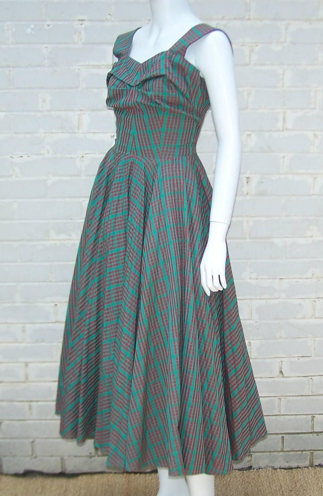 Starting with the red and green plaid fabric and ending with a classic early 1950s silhouette ... this dress is sure to please.  The dress appears to be custom made with hand finishing and an eye for detail.  The bodice is slightly ruched at the
