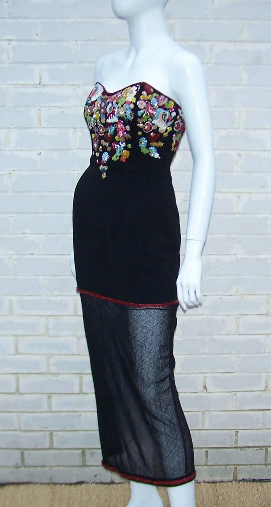 There's a lot going on here and it is all good!  This is a black wool crepe bustier construction strapless dress with heavy beading at the bodice and a sheer panel outlined in red beading on the bottom.  The dress zips at the back and the bodice is