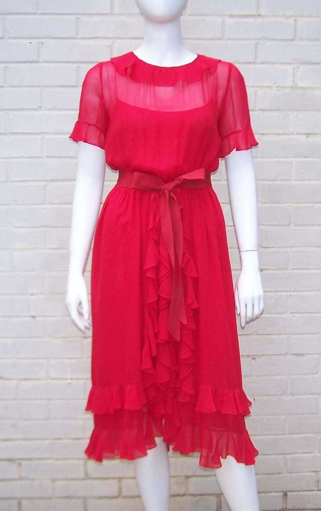 The style says 'coquette' but the color says 'femme fatale' ... put yourself into this 1970's Bill Blass silk chiffon dress and decide which one you will be for the evening.  The gorgeous color of the dress is paired with ruffles at the neck, sleeve