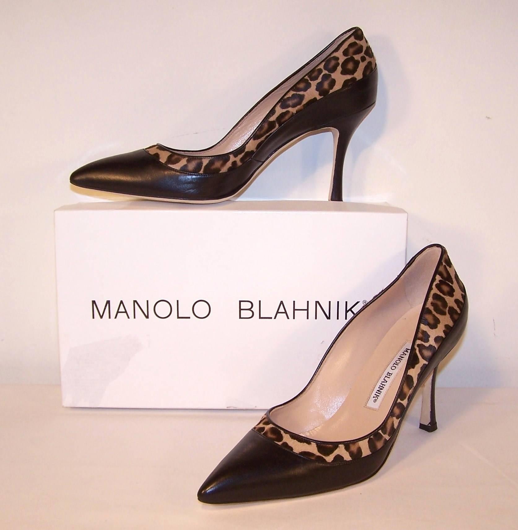 These Manolo Blahnik's are to die for...purchased from Neiman Marcus and never worn.  The body of this classic pointy toe pump is black leather with a vamp decorated in leopard printed pony.  The 3.75" heel is actually comfortable and suitable
