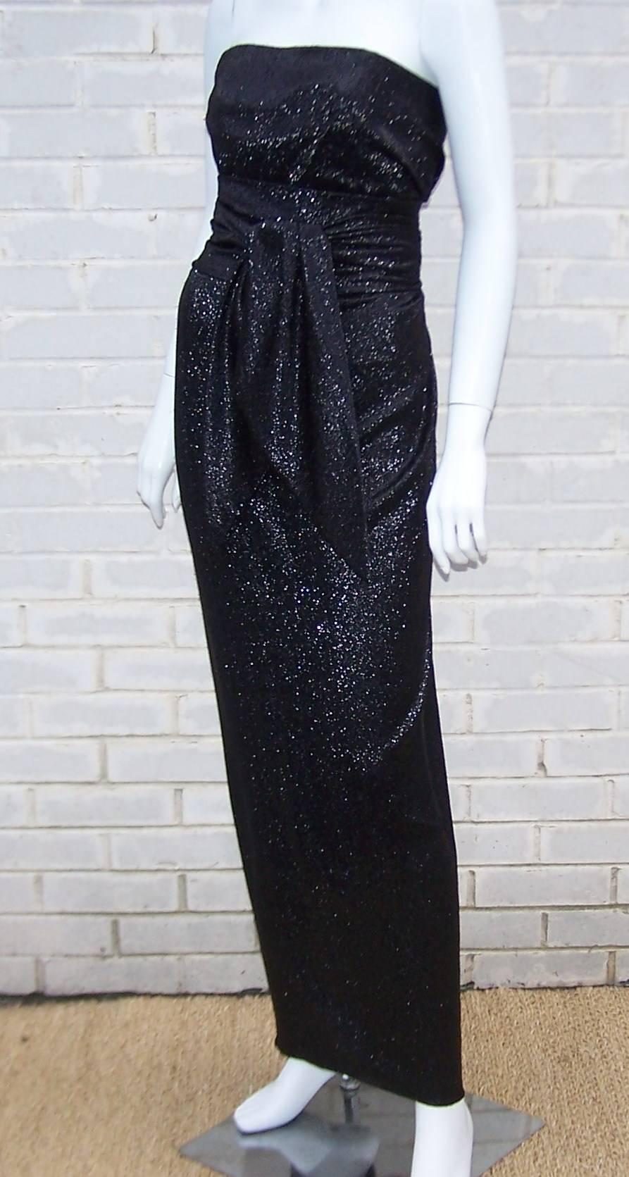 Besides Bill Blass, the star of this show is the amazing black fabric used to create this strapless column dress.  The fabric is laced with silver threading which creates a shiny shimmer of light at every turn.  The dress zips and hooks in the back