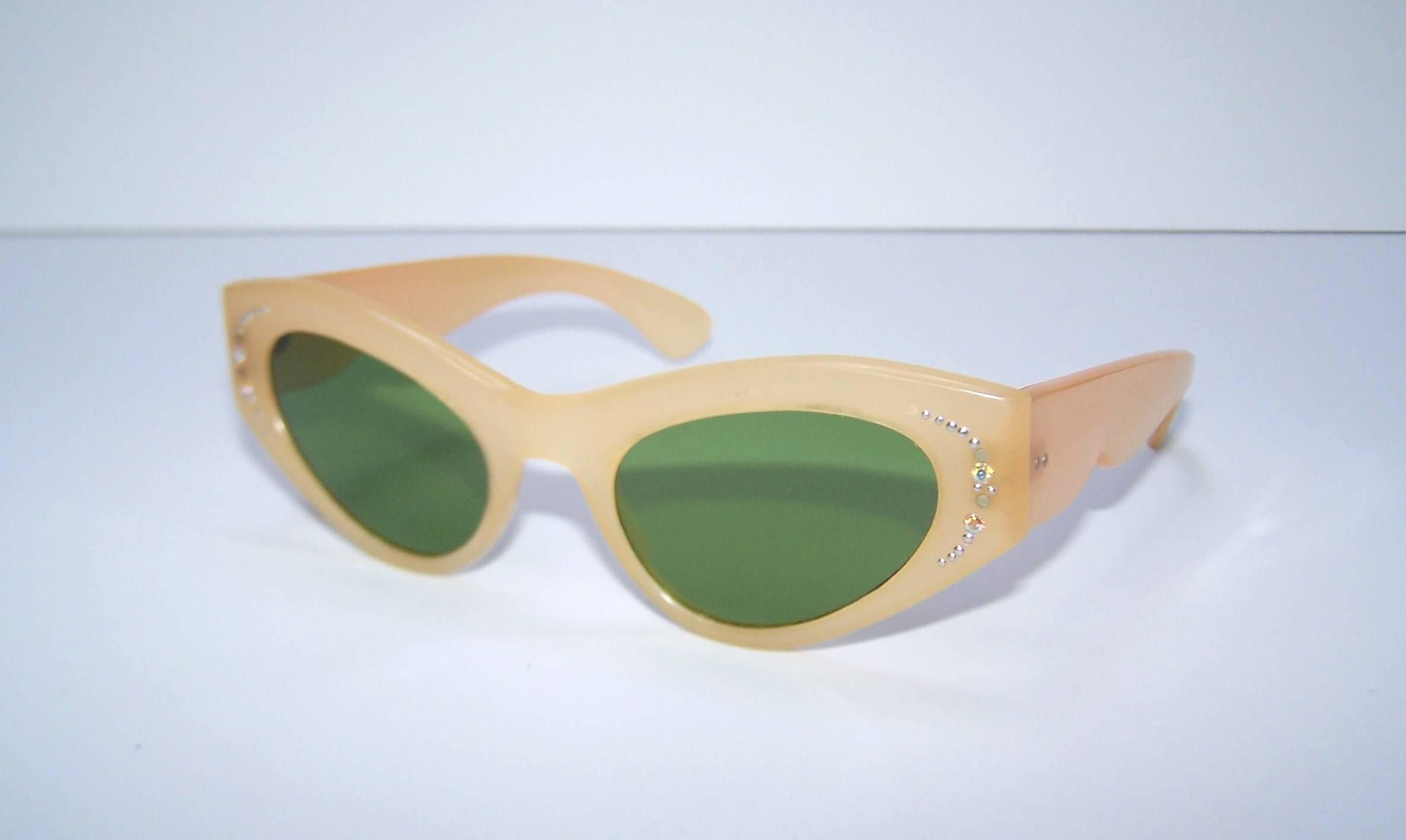 Don't forget your sunglasses when heading to the Riviera...the Italian Riviera in the 1950's, that is!  These classic cat eye sunglasses are a flesh tone or blonde frame with emerald green lenses and a little sparkle at the temples.  Marked 'Italy'