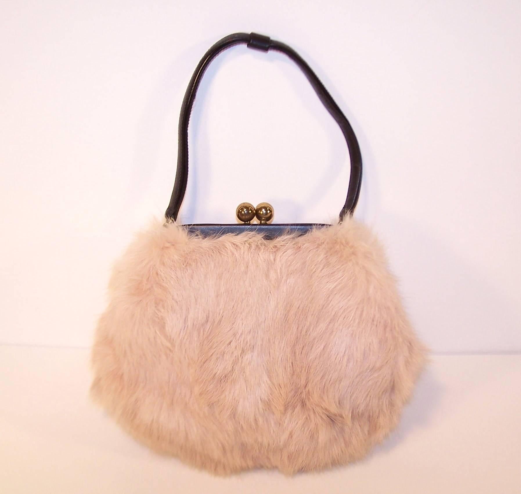 Everybody will want to touch this ballerina pink fur handbag by Morris Moskowitz ... and who could blame them.  This sweet little design has a black leather frame and handle with a kiss lock closure and silk faille lining.  The original coin purse