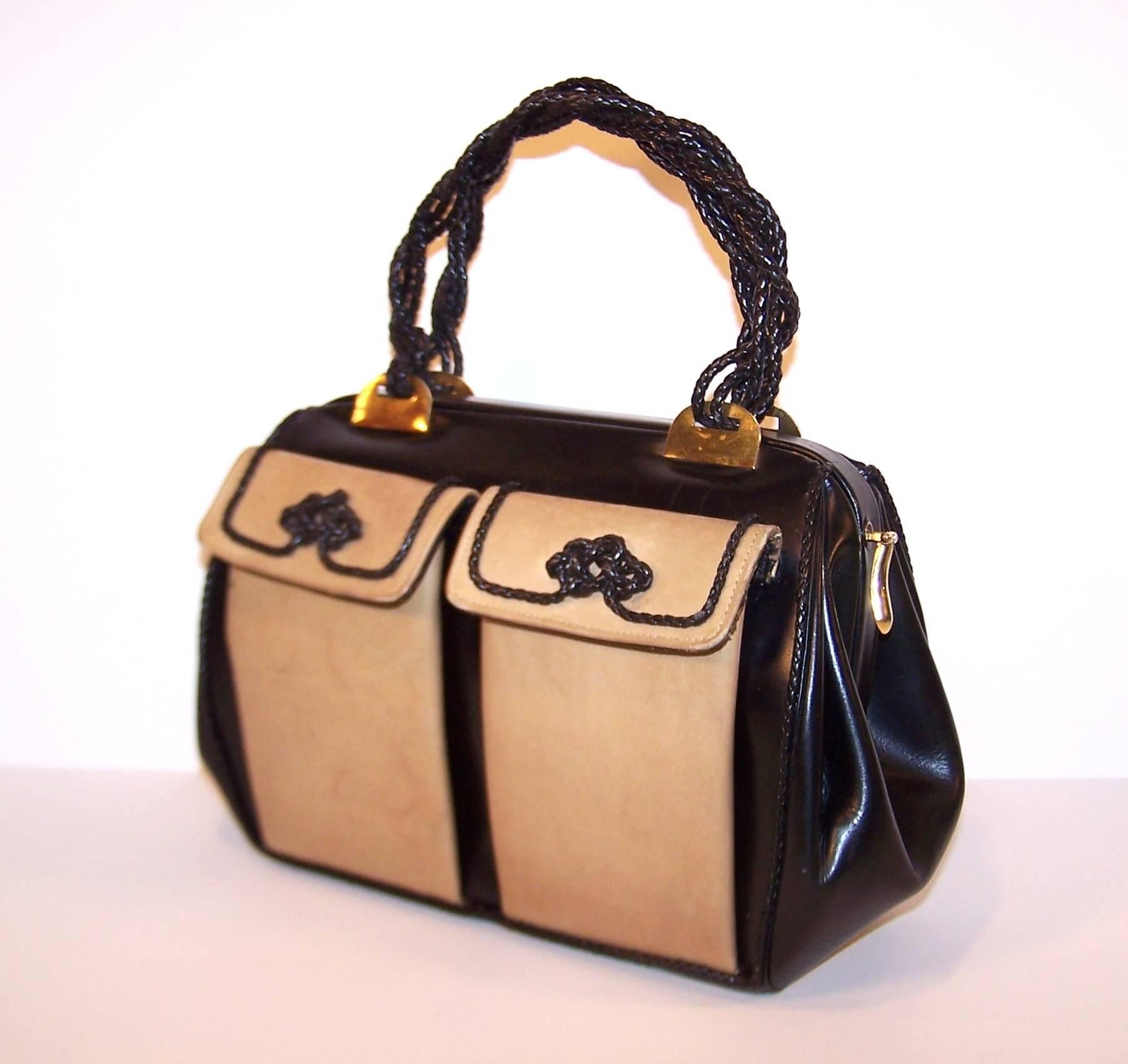 Roberta di Camerino handbags are always unique and innovative.  This handsome example features a two tone leather combination of black and taupe with braided leather trim and handles.  The front pockets snap closed and make a perfect compartment for