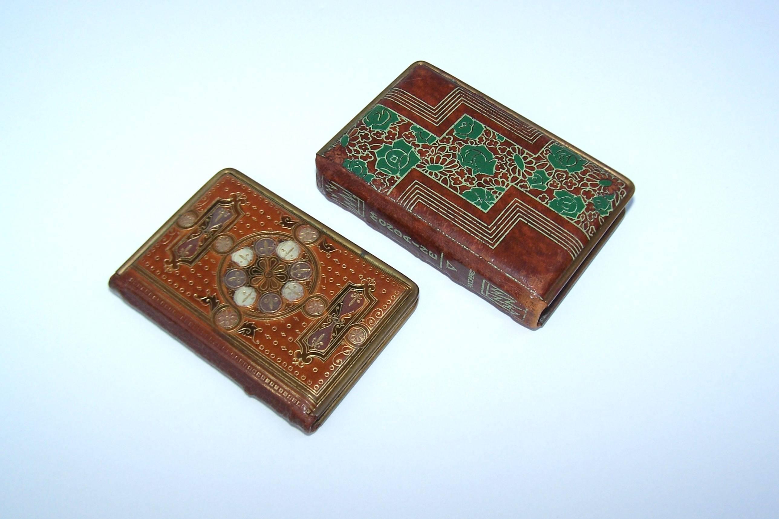 These charming tooled leather powder compacts by Mondaine of New York are made to resemble miniature leather bound books.  The larger one measures 3