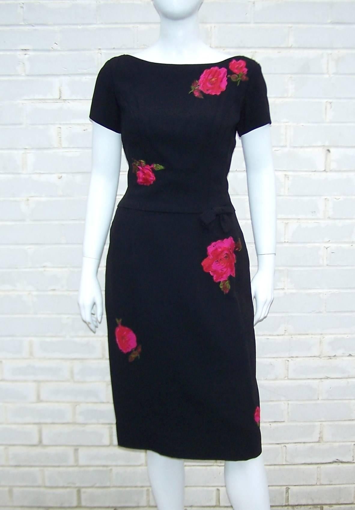 The 'little black dress' with a wiggle and a splash of color...perfect for many occasions and a great vintage staple for your wardrobe.  This little gem is a wool crepe style fabric with scoop back, bow detail and vibrant fuchsia pink and red rose