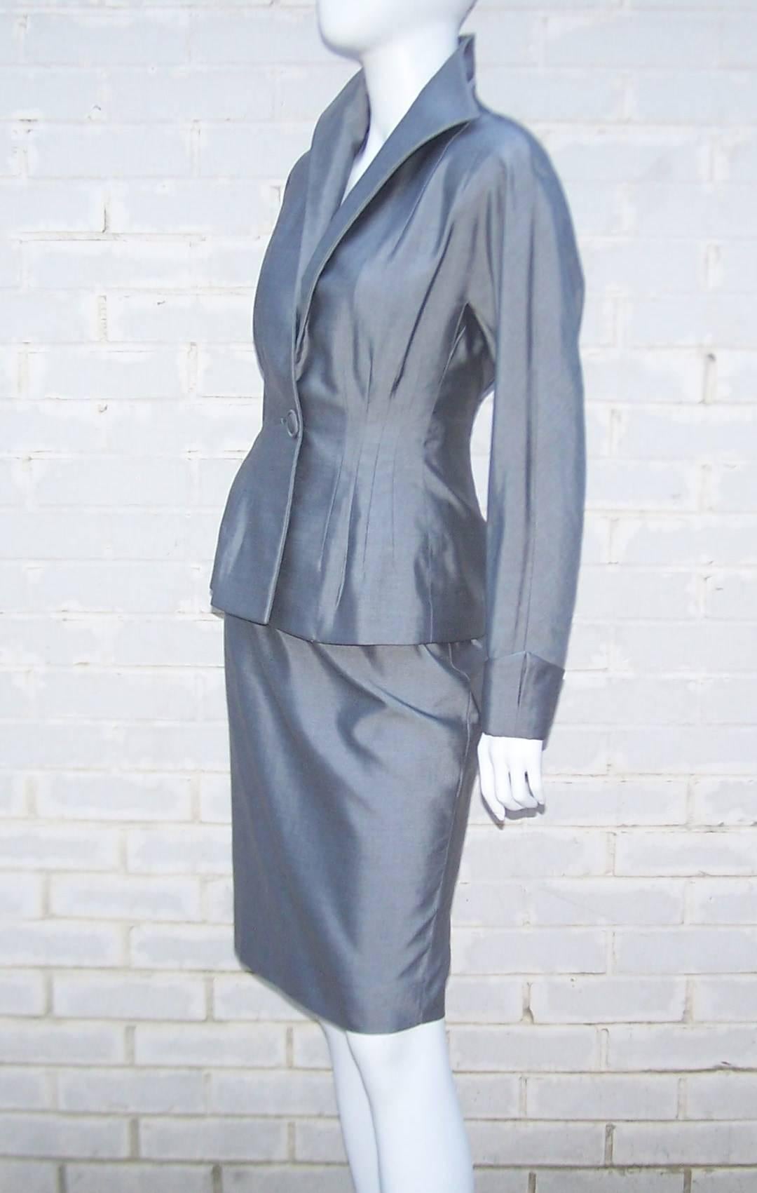 This Anne Klein suit is the best of both worlds ... modern sensibility with a 1940's inspiration.  The two piece skirt suit is a cotton and silk blend sharkskin fabric in light gray.  The darts on both the skirt and jacket waist gives the suit a