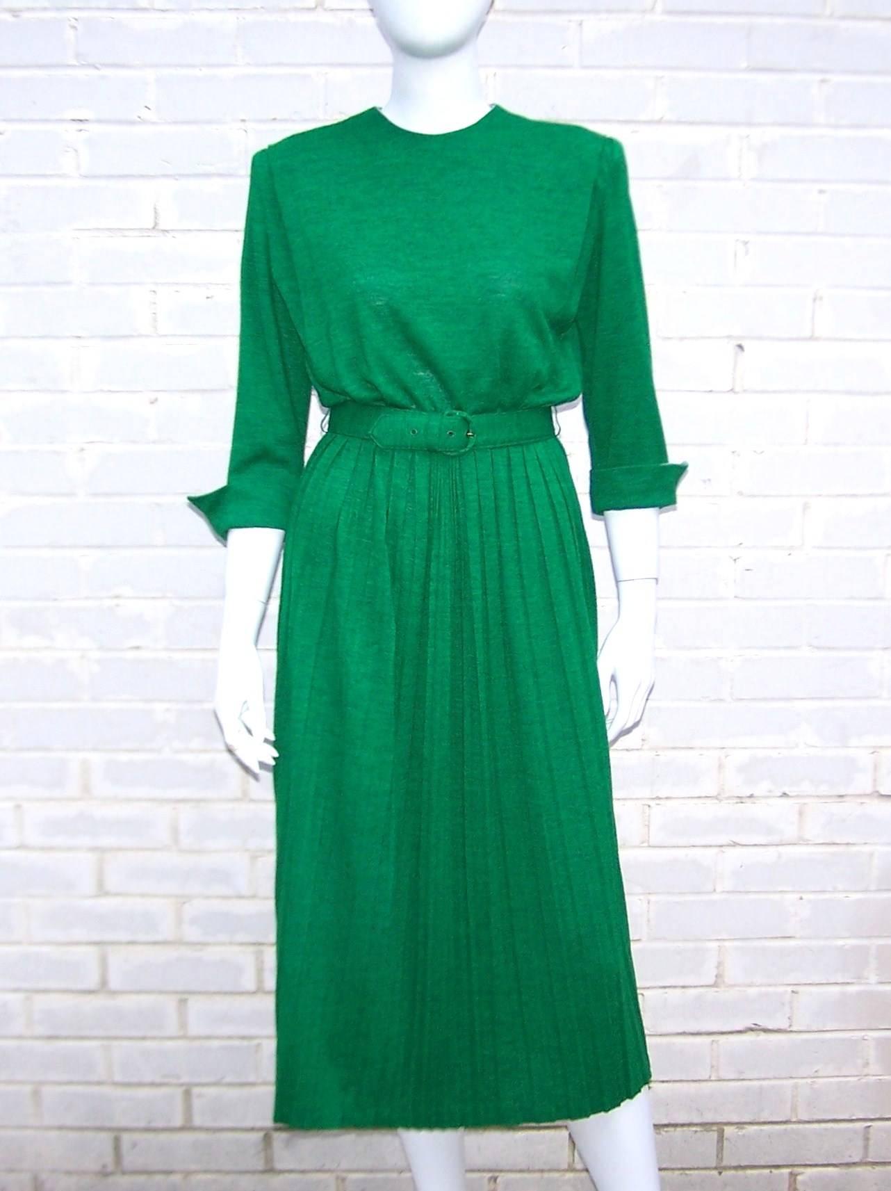 This versatile emerald green  and gray wool knit dress by Debby of California has lovely details and can be dressed up or down.  The bodice has soft shoulder pads and darts to create a flattering silhouette.  The skirt is micro-pleated and has a