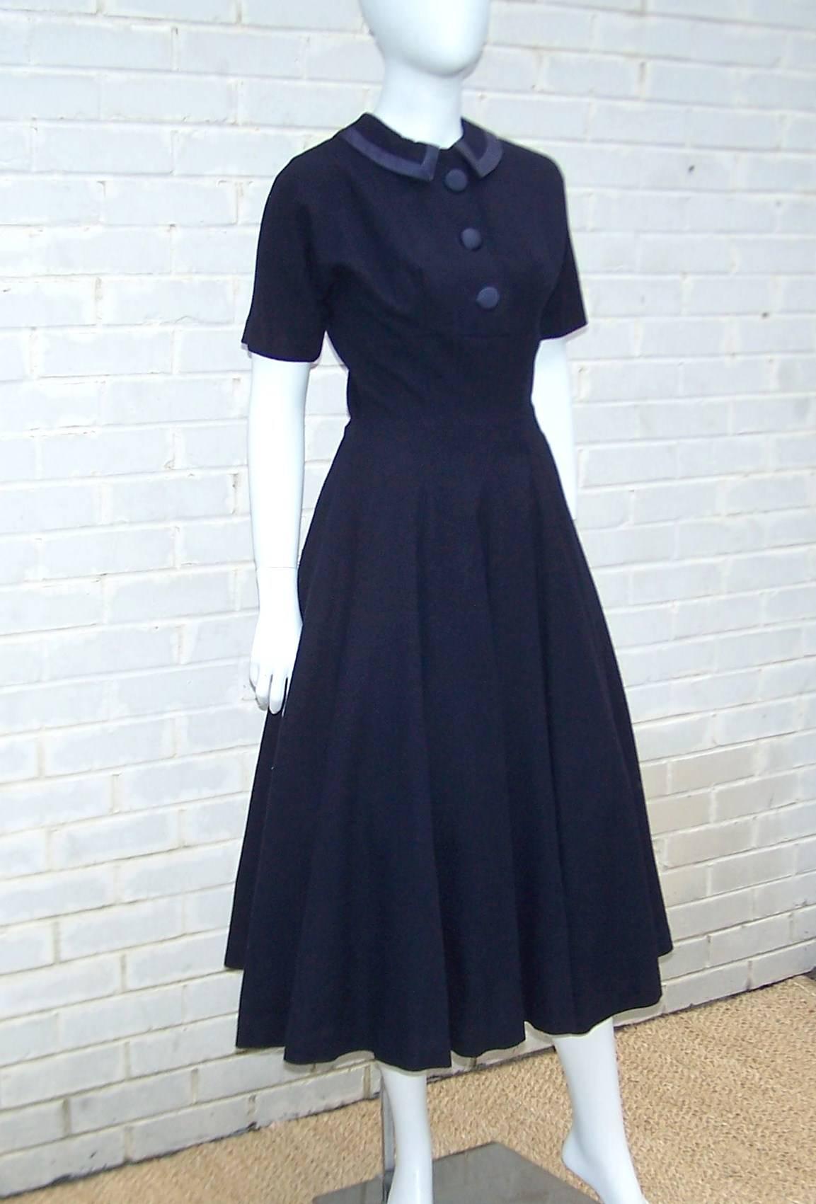 Classics never go out of style.  This wool and satin 1950's dress by 'Junior Circle' proves the point.  It is a classic 1950's silhouette...Peter Pan collar with fitted torso and full swing style skirt.  Add a few design surprises like the blue