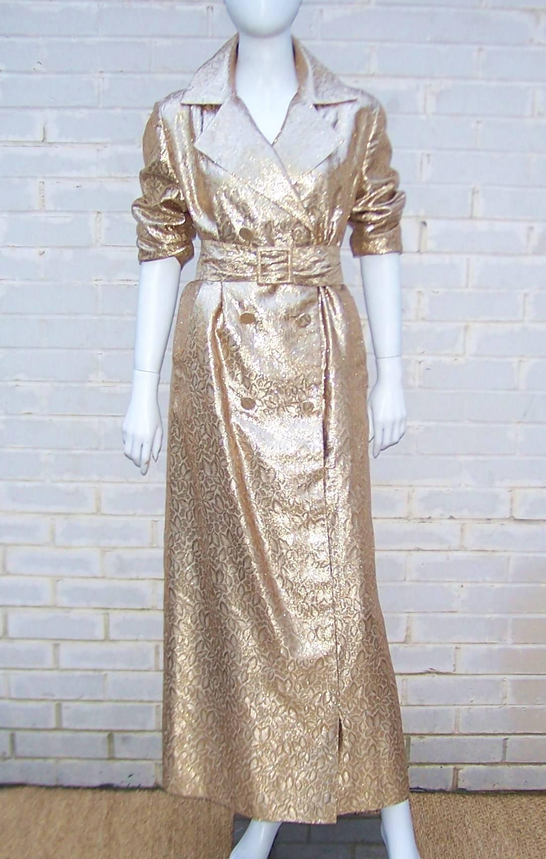 Gotta date with Goldfinger?  At least dress the part in this fun gold lame trench coat style dress by Lawrence of London.  The gold lame fabric has a foliage jacquard print for added visual interest.  The double breasted design has a built in 3