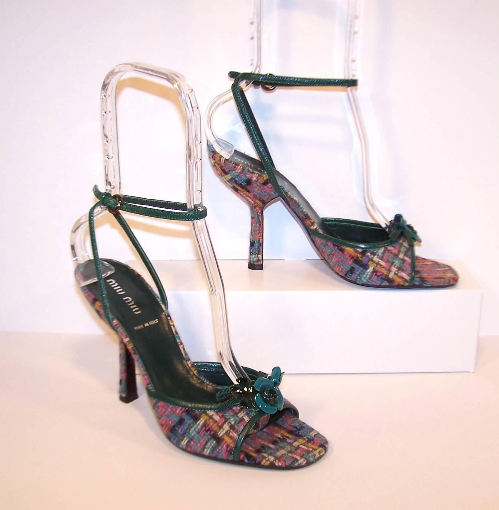 These contemporary Miu Miu sandals are reminiscent of ladylike strappy sandals and peep toe shoes from the 1950's.  The body and heel are wrapped in a colorful wool tweed ... pink, purple, winter white, charcoal, blue and green.  The trim and straps