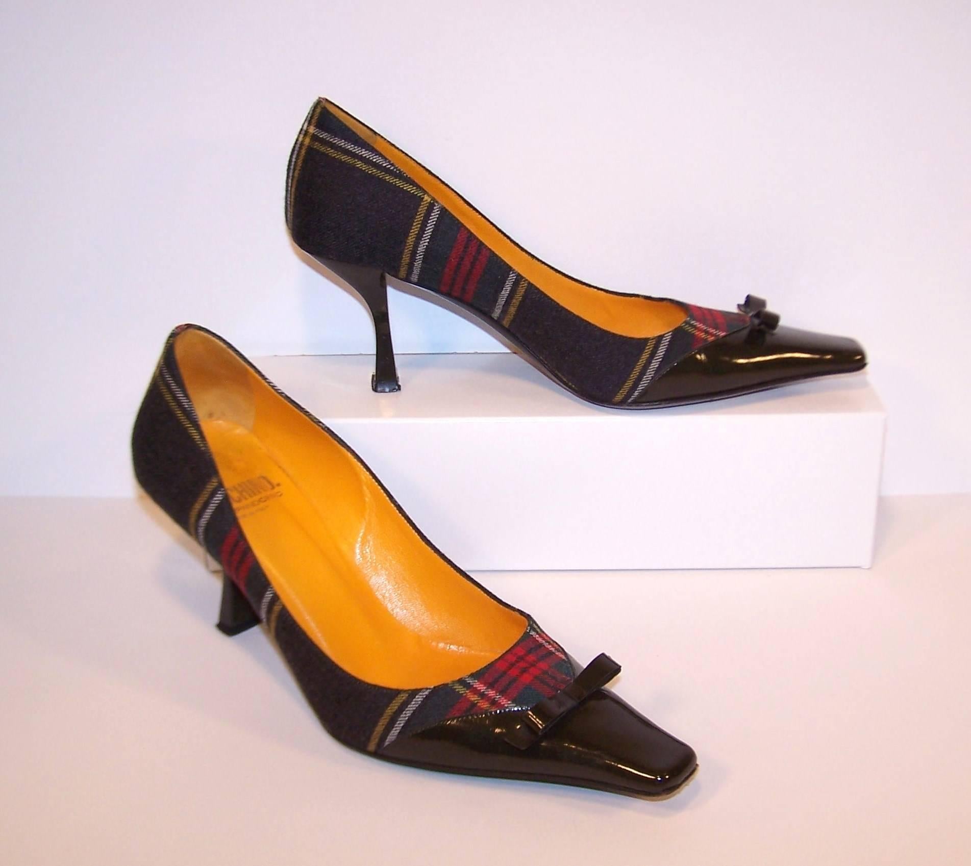 We're mad for plaid and Moschino's Cheap & Chic wool pumps fit the bill!  The body of the shoe is a charcoal gray wool plaid with red, white and yellow highlights.  The snubbed nose pointy toes and stylized 3" heels are a gray-brown patent