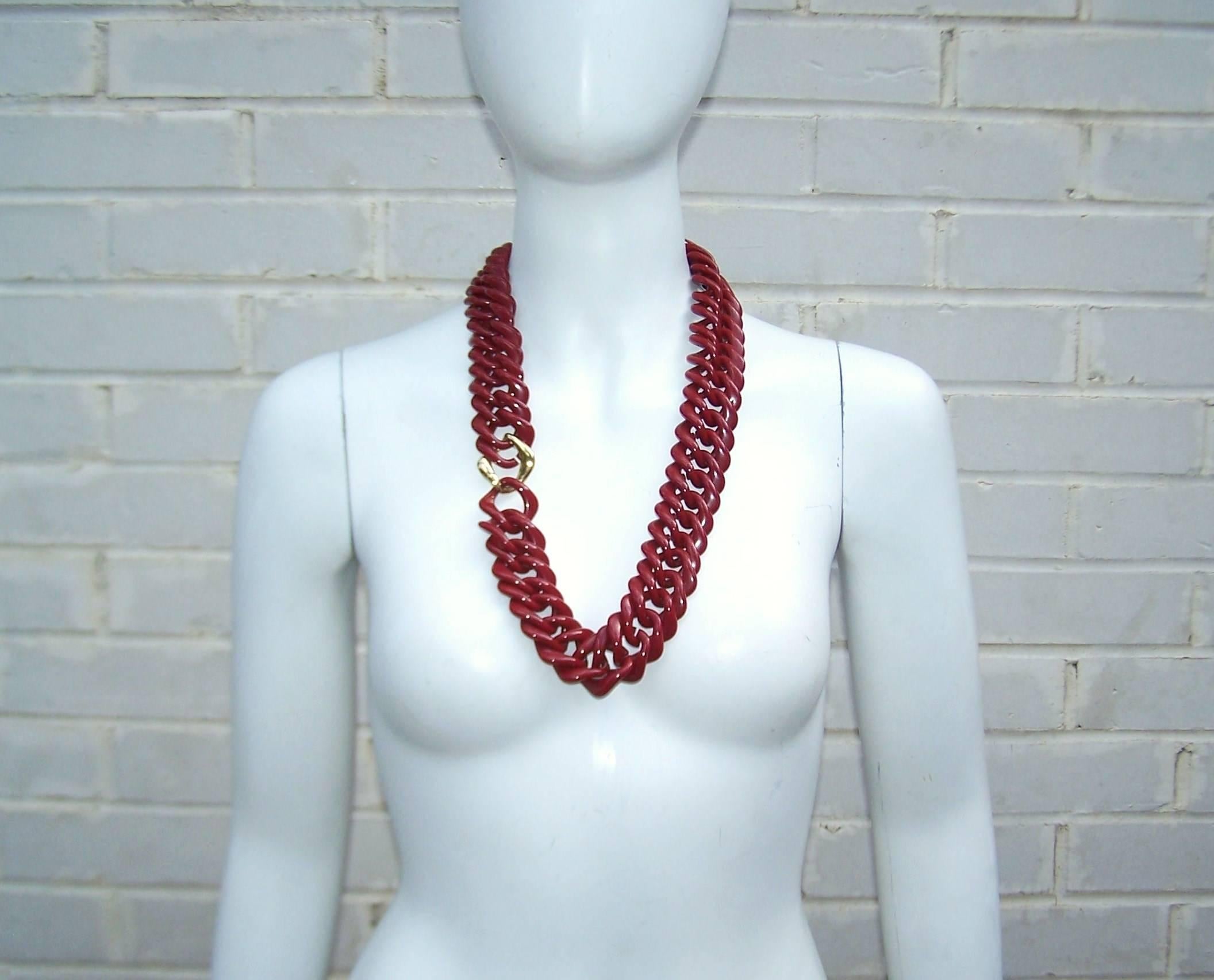 Transform your look with this vintage Trifari necklace.  The chunky chain has a weighty appearance though it is deceivingly light and comfortable for all day wear.  The sinewy style is formed by interlocking square plastic links in a dark burgundy