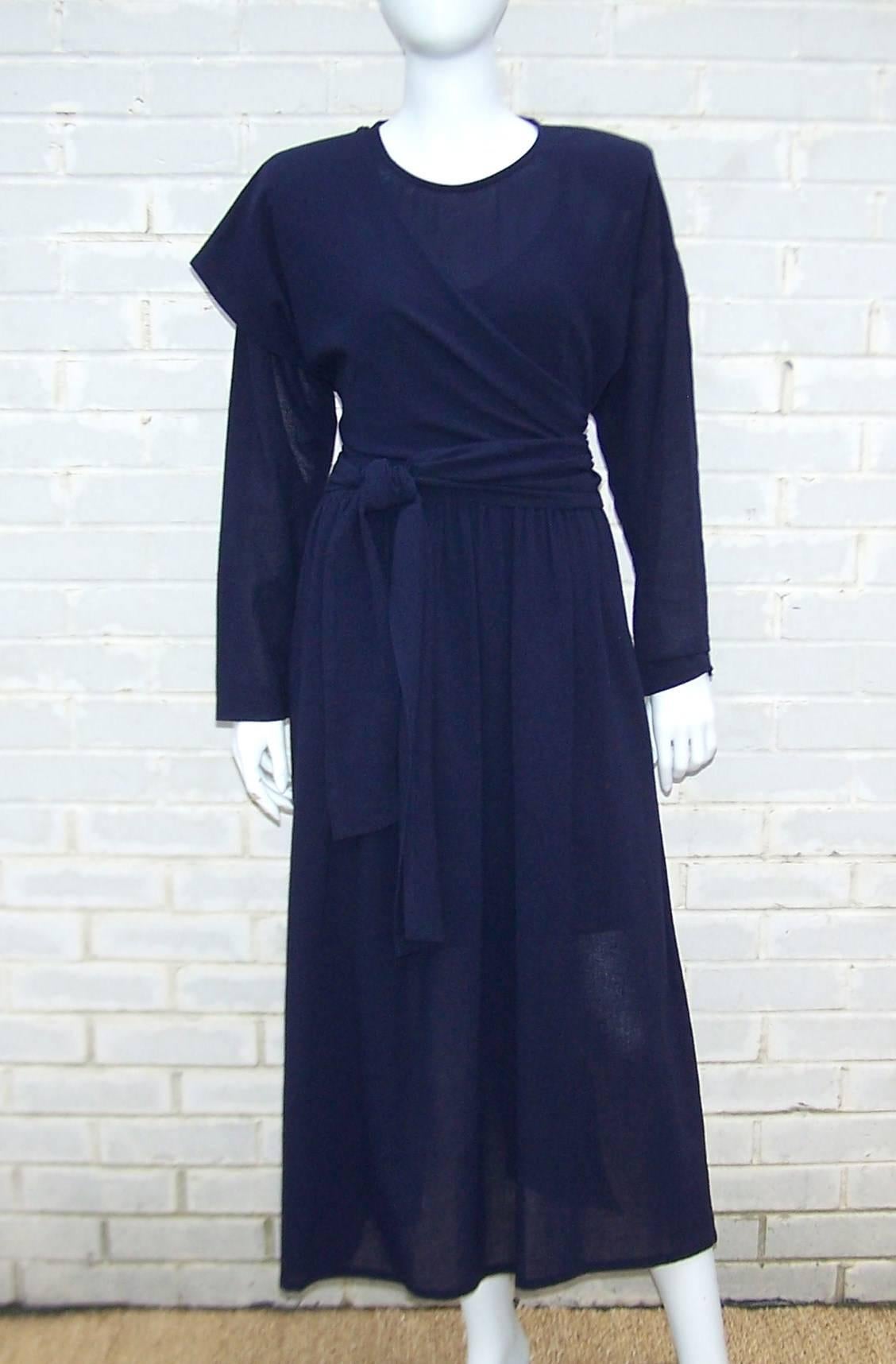 We love the futuristic austerity of this 1980's Sonia Rykiel design.  The deconstructed navy blue dress is a sheer weave cotton with a dolman style bodice and full skirt with soft pleating at the relaxed waist and side pockets.  The wrap is provided