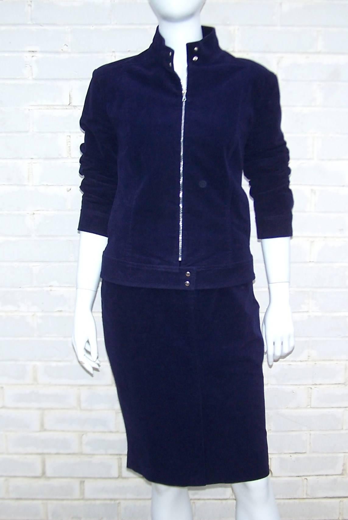 This blue velveteen suit by Richard Tyler has all the details of a denim suit with form fitting structure and relaxed style.  The cafe racer style jacket zips and snaps at the front with side pockets.  The skirt buttons and zips at the front with a