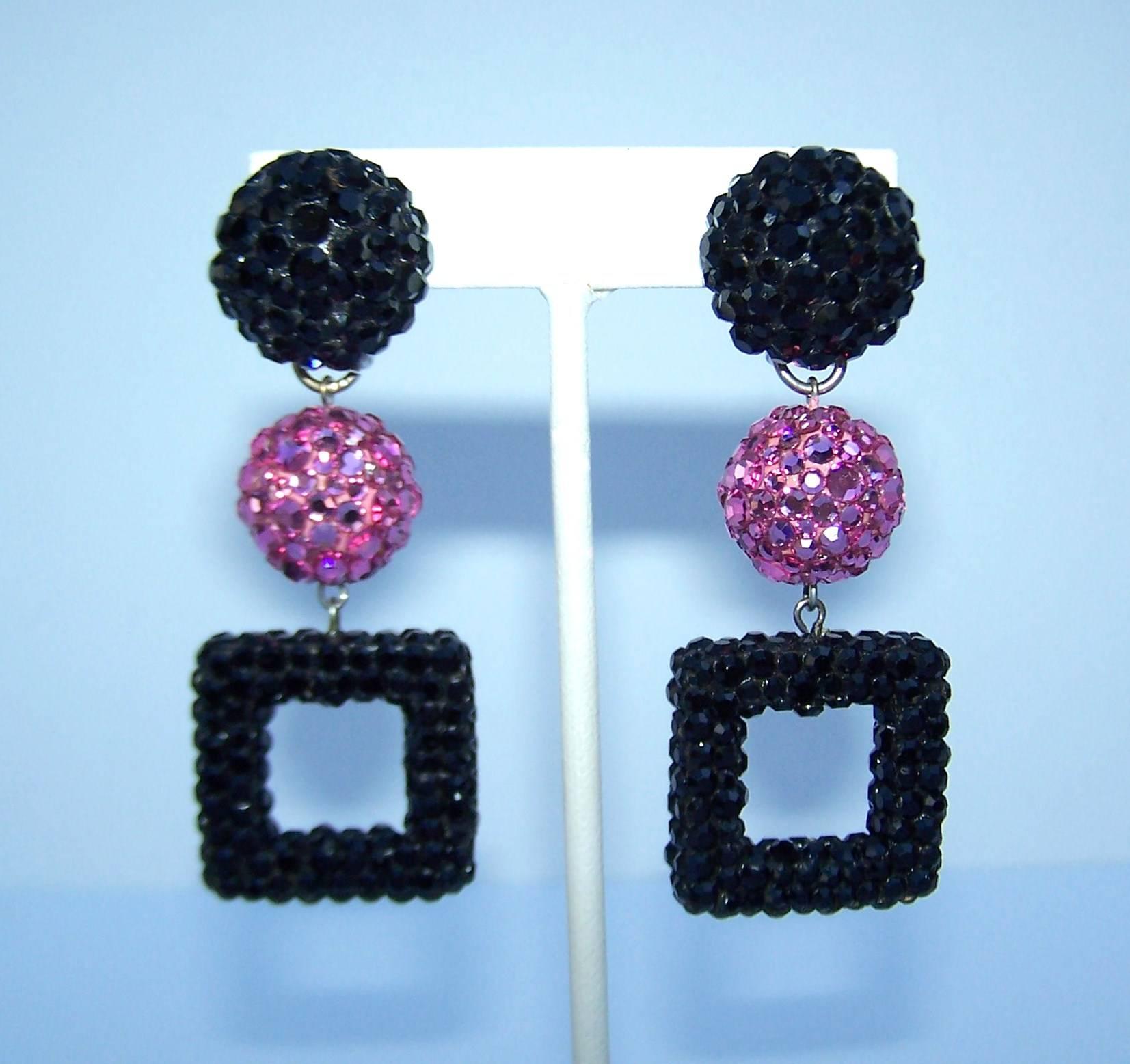 These earrings call for heavy eyeliner, pale pink lips and a mini dress.  Though unmarked, they appear to be a 1980's James Arpad design with a nod to the mod styles of the 1960's.  Black and pink pave crystal encrusted orbs suspend a square drop