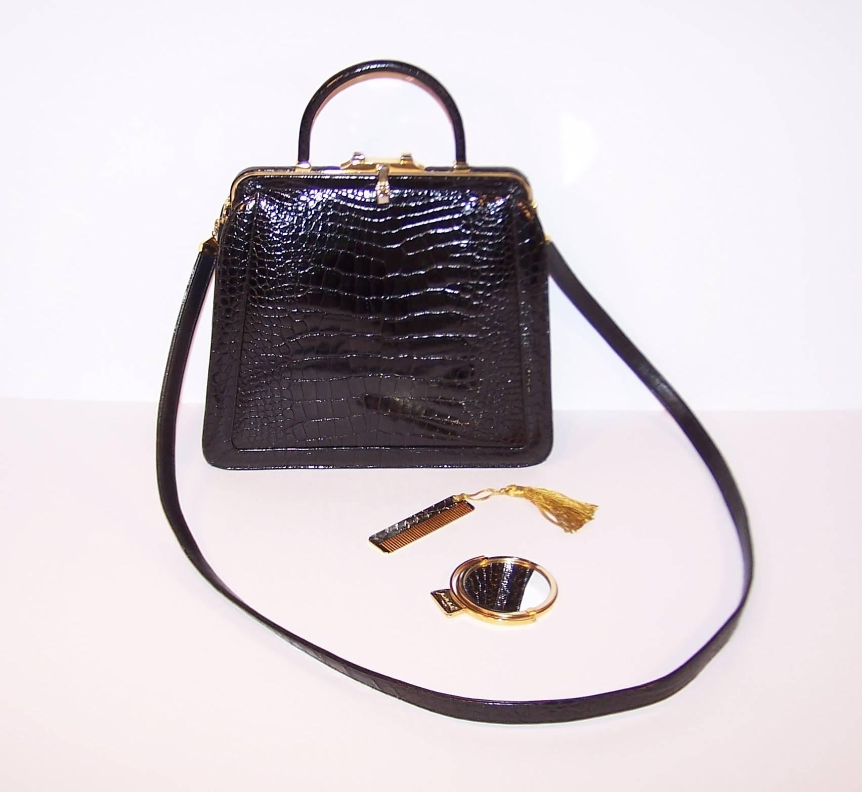 Just like a classic 'little black dress', every wardrobe needs a classic black handbag.  This Judith Leiber black alligator handbag is beautifully designed with the practical option of using the top handle or the detachable shoulder strap.  The gold