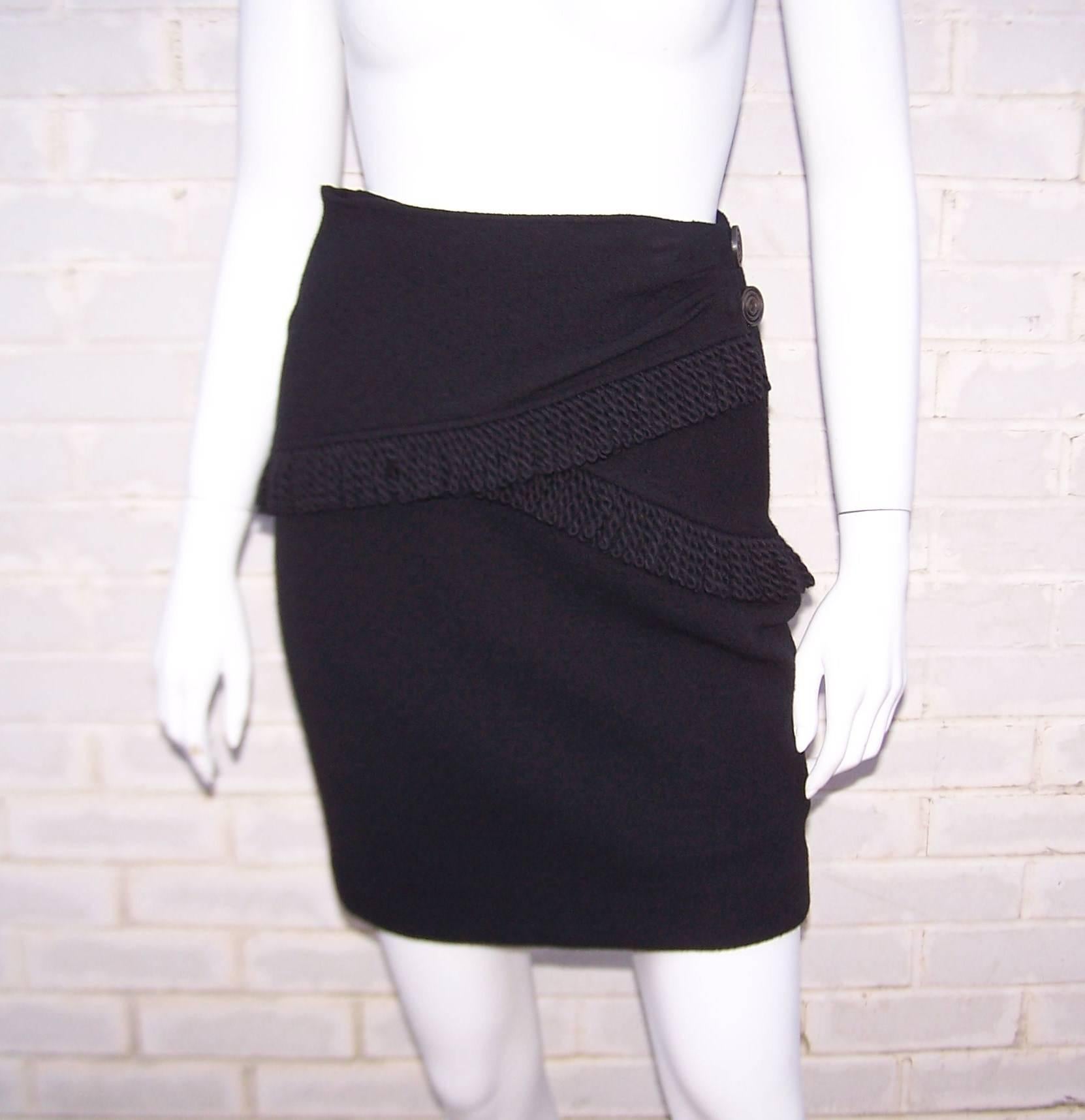 Heavy fringe and a sarong style waist wrap give this Yves Saint Laurent Rive Gauche skirt a fun and flirty look.  The black wool boucle fabric has stretch to emphasize your best assets and a little well placed fringe at the back makes for fun