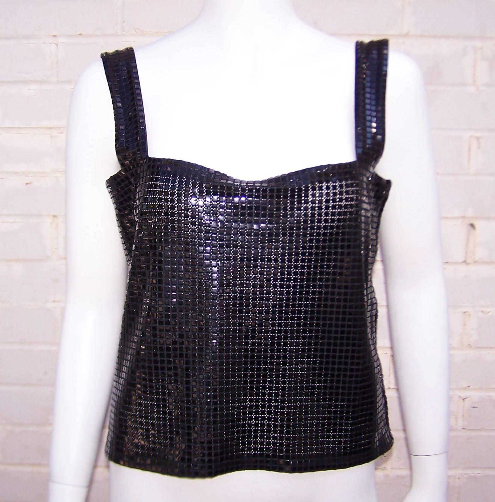 Fashion forward yet reminiscent of the 1960's mesh styles of Paco Rabanne, this Krizia space age black top can function as the centerpiece to an outfit or a functional shell to add under a jacket or wrap.  The top is a cotton backed fabric with
