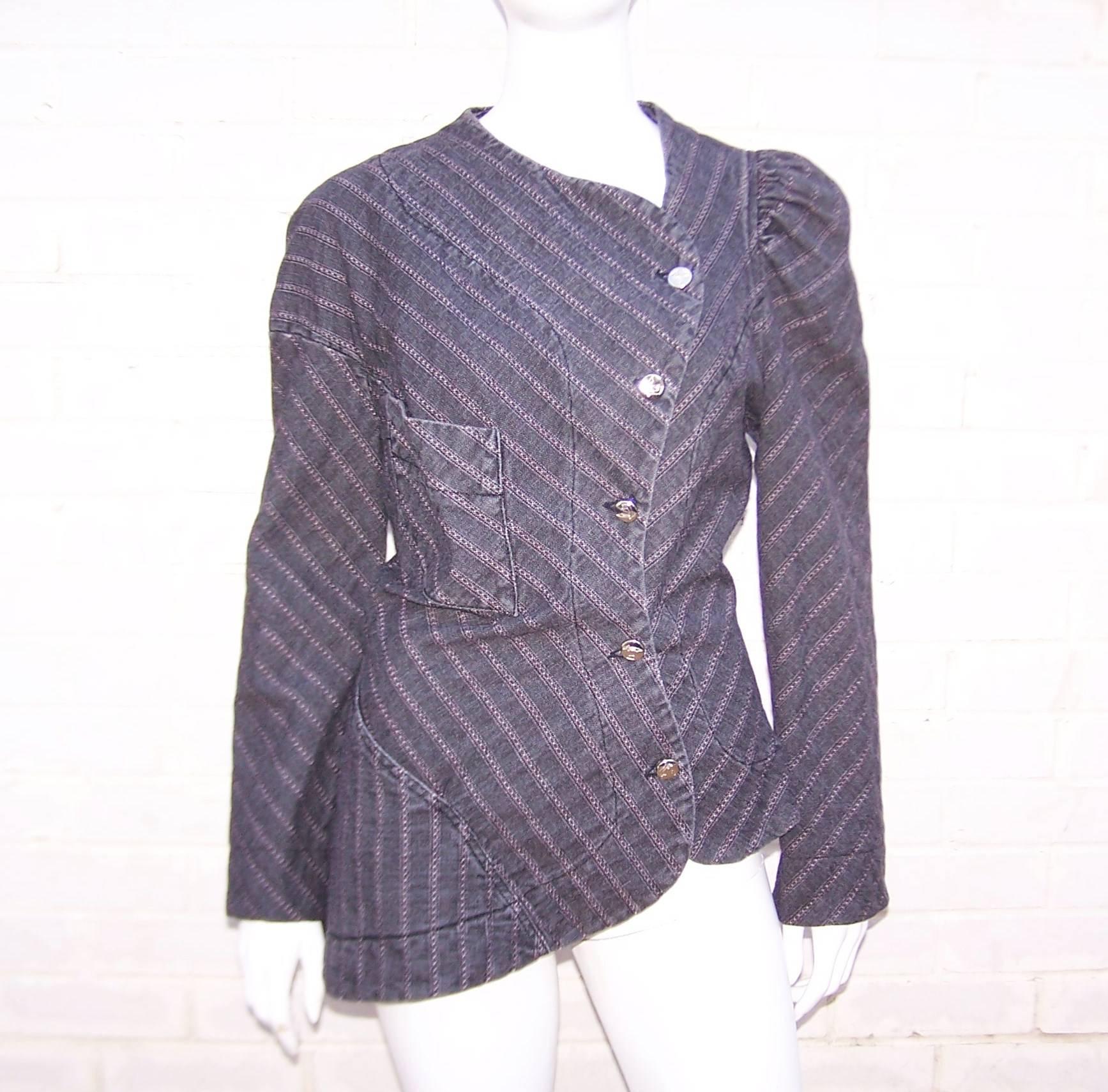 Ahoy, matey!  This oh so fun Vivienne Westwood charcoal denim pin striped jacket is from the pirate collection.  The denim fabric has light stretch perfect for the asymmetrical shapes and angles of the silhouette.  The asymmetrical peplum and