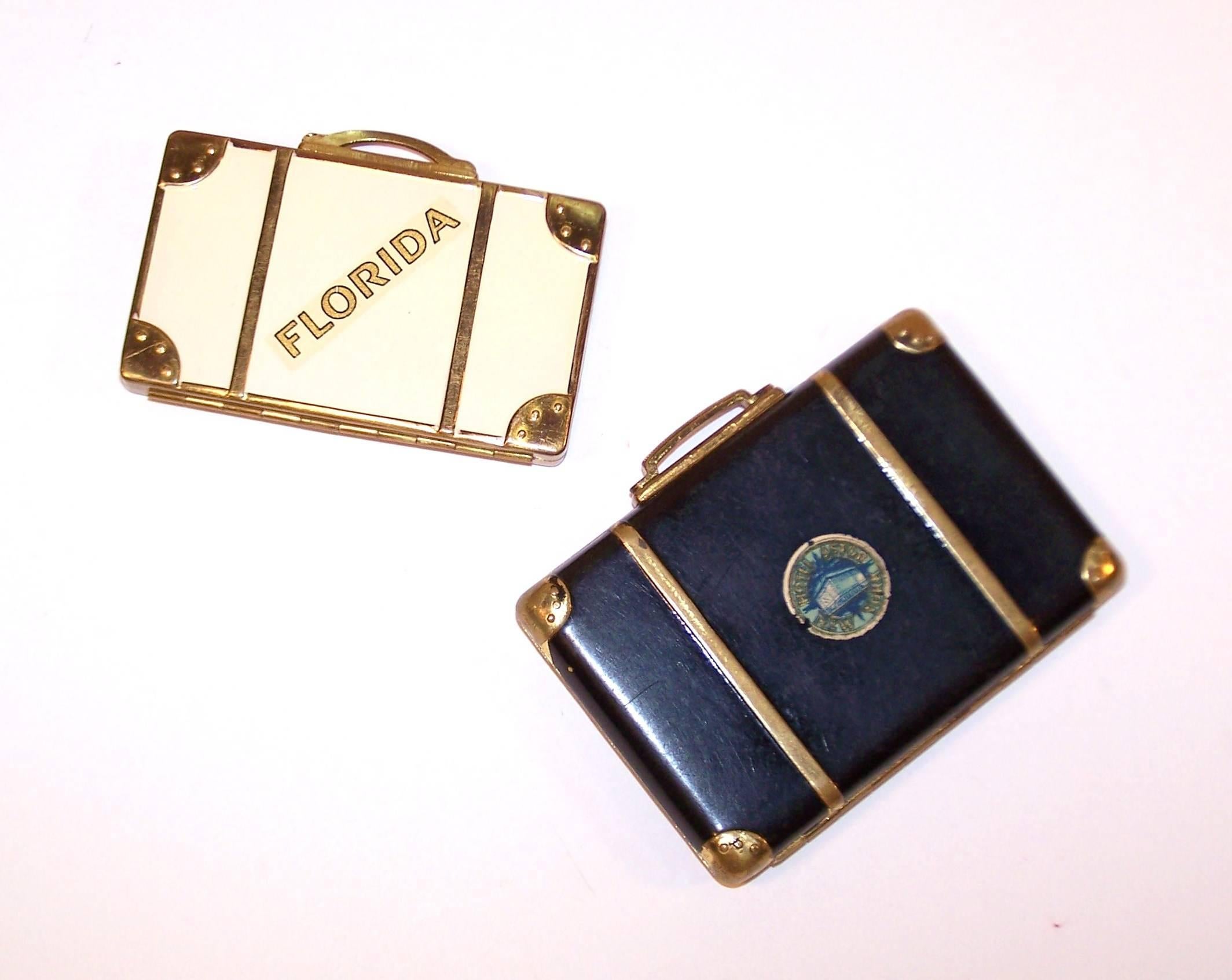 Supersized is fun but miniatures rule!  These adorable 1940's powder compacts are designed to resemble well traveled suitcases complete with trompe l'oeil buckled straps, rivets and destination badges.  The handle depresses to reveal a mirrored two