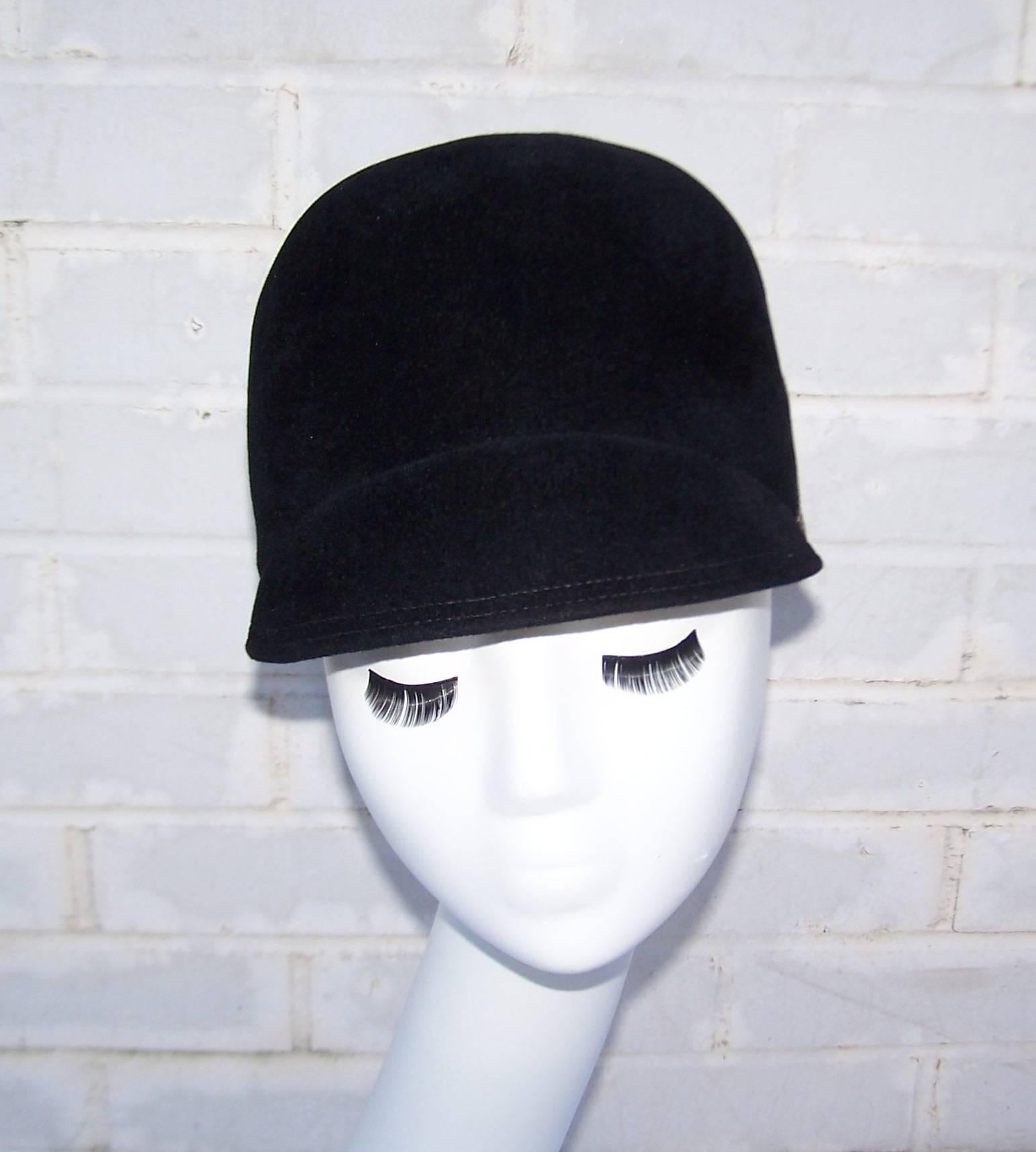 Sporting style meets the mod fashions of the 1960's in this black wool riding cap by Modern Miss.  The crown is decorated with black grosgrain ribbon accented with contrast stitching.  Adorable paired with a period perfect coat and functional for