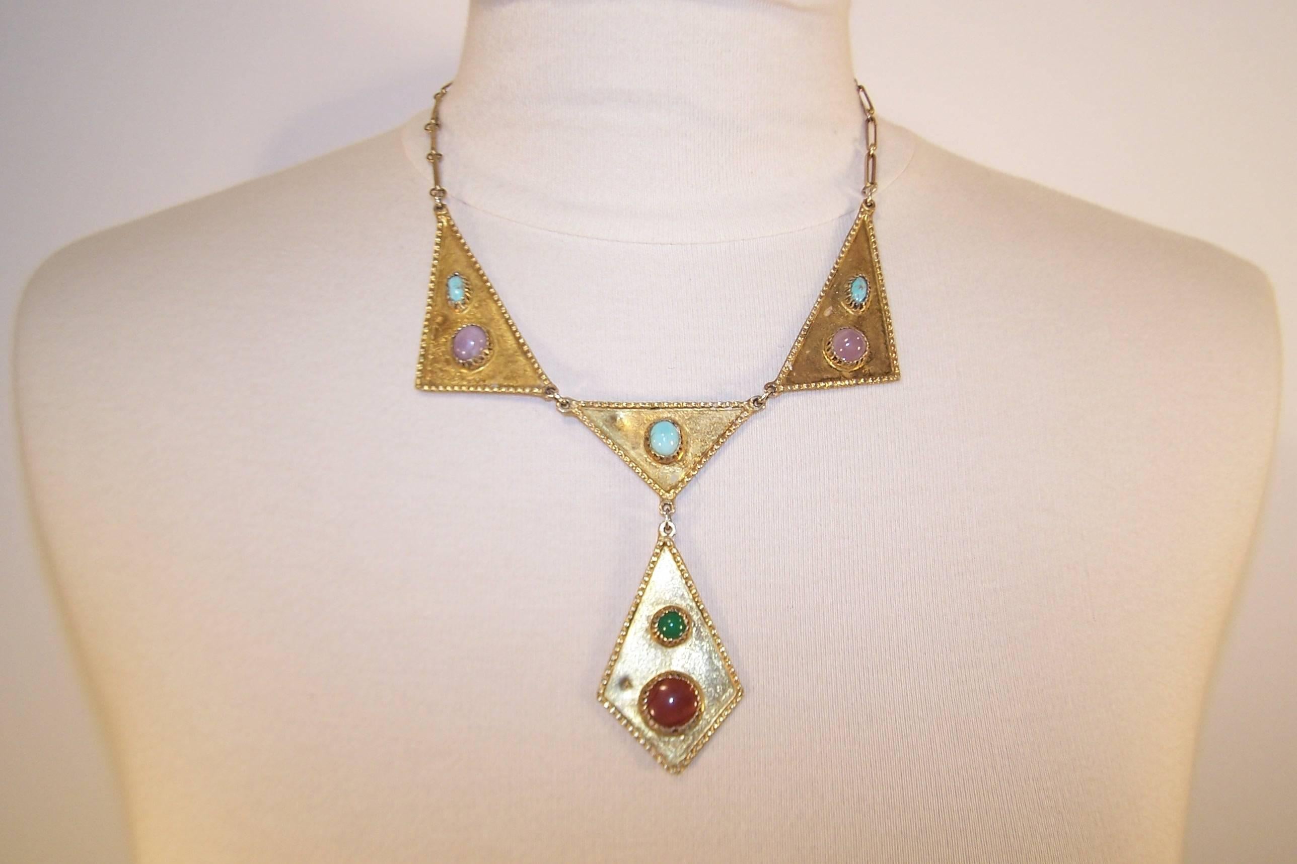 Style yourself like an Egyptian queen with this bib necklace handmade from vermeil silver with semi precious stones.  The artisan designed necklace consists of 4 triangular shapes in a drop pattern with crimped edging.  The link chain secures with a