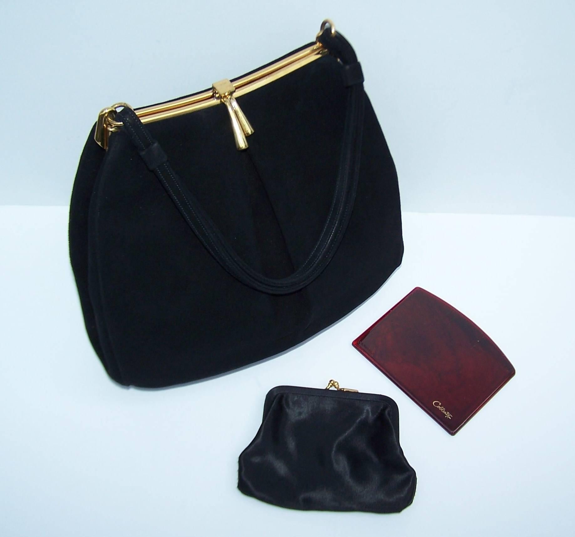 This 1950's Coblentz handbag has all the charm of a vintage design with a roomy interior that functions well for modern day 'accoutrements'.  In other words, there is room for your stuff!  The black suede body and gold metal frame can function as a