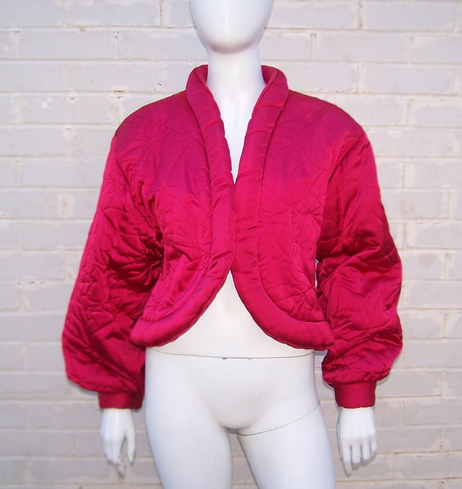 Get it while it's hot!  Hot pink, that is!  This cozy cropped jacket has all the comfort of a modern day puffer but with the expert tailoring of Guy Laroche.  The fuchsia pink satin is quilted and styled to create a cutaway look that can go dressy