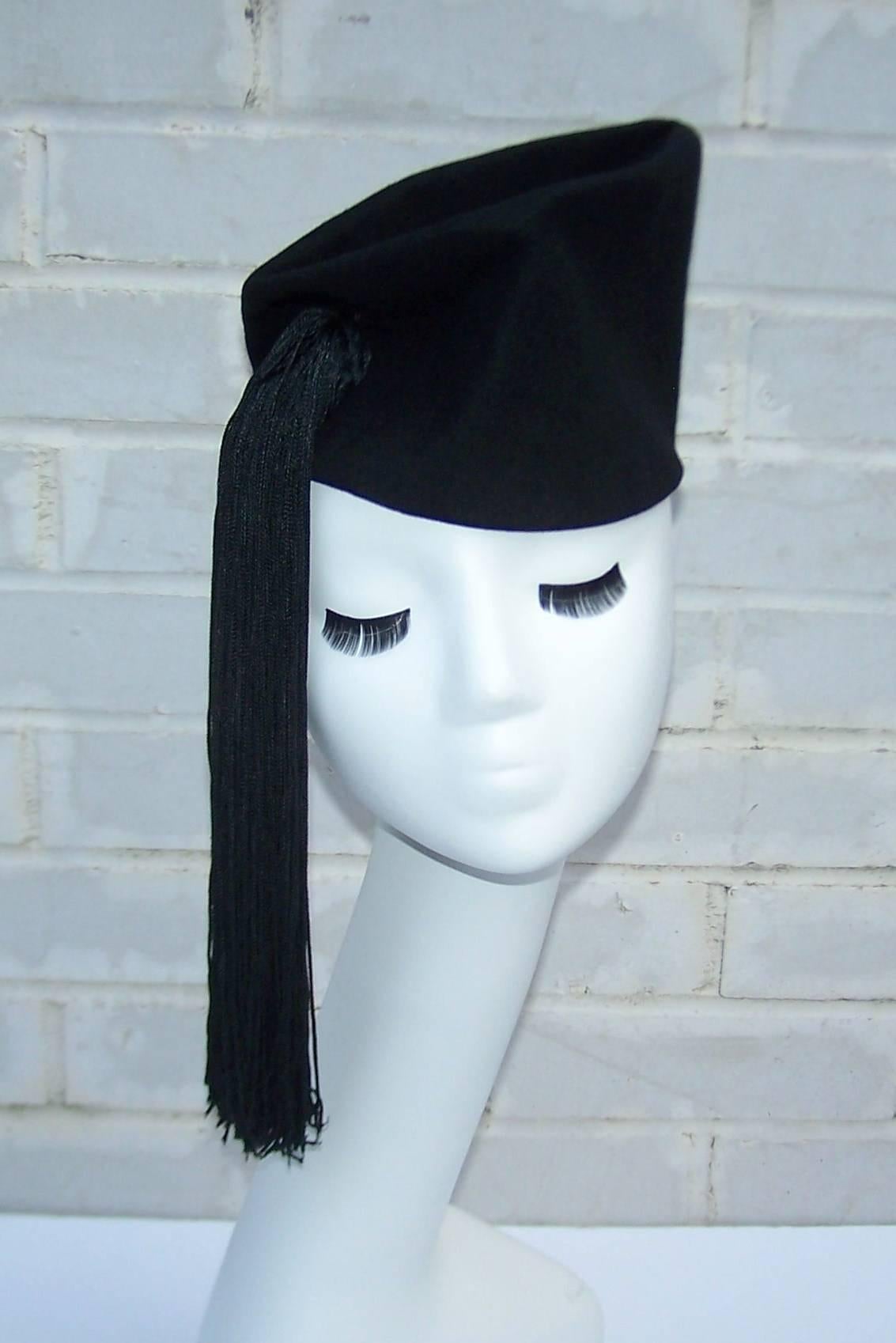 This fashion forward hat from Roberts Bernays is a black wool body with expert shaping decorated with a long silk tassel.  Create a dramatic 1940's period perfect look by tilting it to the side or wear it high on the head for extra height.  Fun for