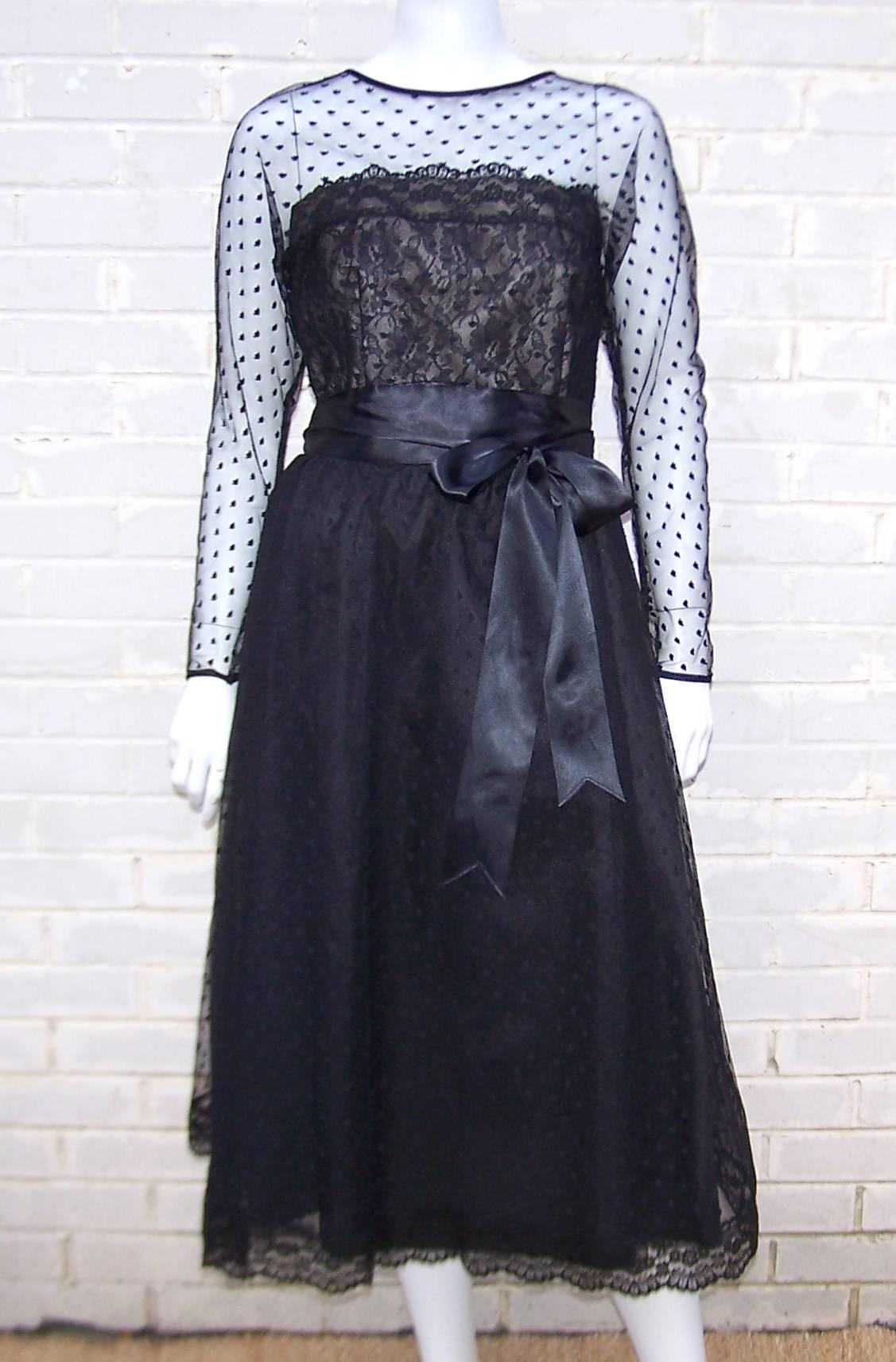 Victor Costa earned a name for himself by designing fashionable and yet affordable evening wear with a nod to the higher end American and French designer labels.  This classic black lace dress is strongly influenced by the nude illusion designs